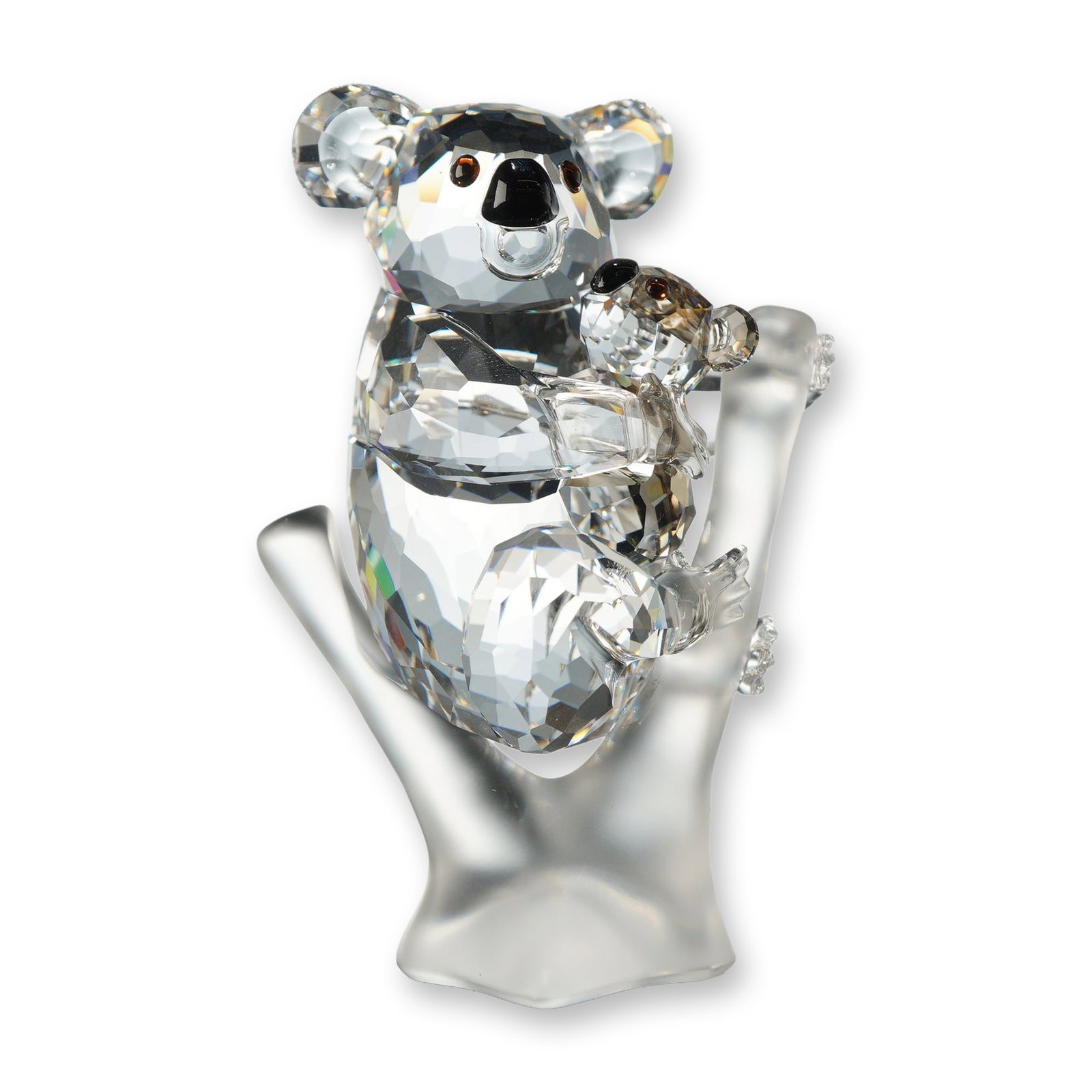 Swarovski Crystal Koalas Figurine: Swarovski crystal figurine depicting a mother koala and baby clinging to a frosted crystal branch. The koalas are crafted in faceted clear crystal with black and brown crystal accents defining the eye