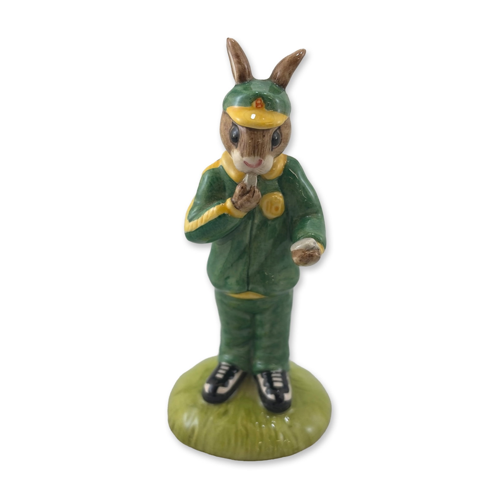 Royal Doulton Stop Watch Bunnykins Figurine DB 253: Royal Doulton. Stopwatch Bunnykins figurine in hand-decorated glazed ceramic, featuring a rabbit figure in a green tracksuit with yellow trim, a matching visor, and black and white athletic shoes. The