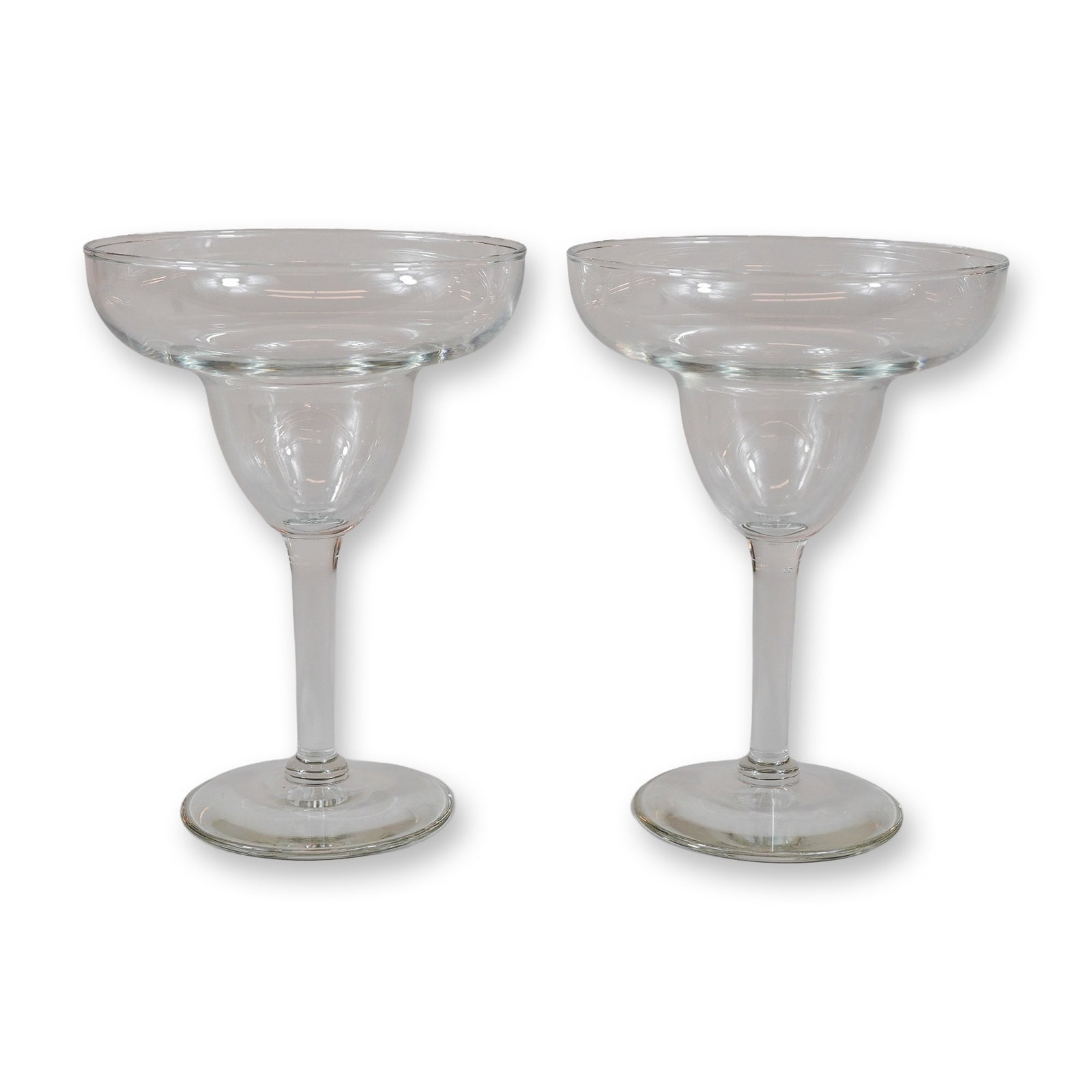 2pc Clear Glass Margarita Glasses: This set of two clear glass margarita glasses features a classic double-bowl design, characterized by a wide and shallow upper rim that tapers into a smaller, rounded lower bowl. Each vessel is suppor