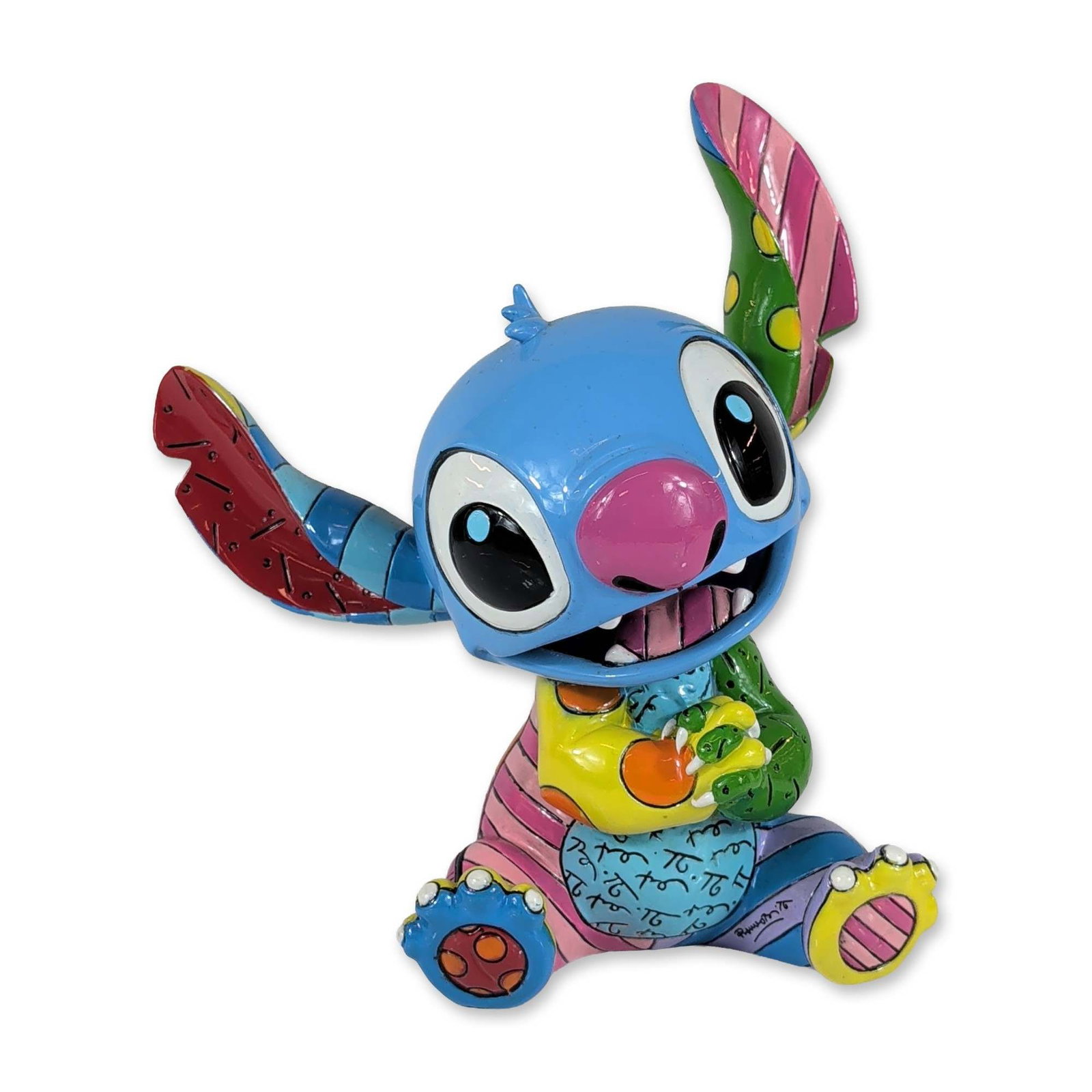 Disney by Britto Stitch Pop Art Resin Figurine: Disney by Britto stone resin figurine of the character Stitch from Lilo and Stitch, designed by artist Romero Britto. The figure is depicted in a seated pose with an open mouth, rendered in a pop art