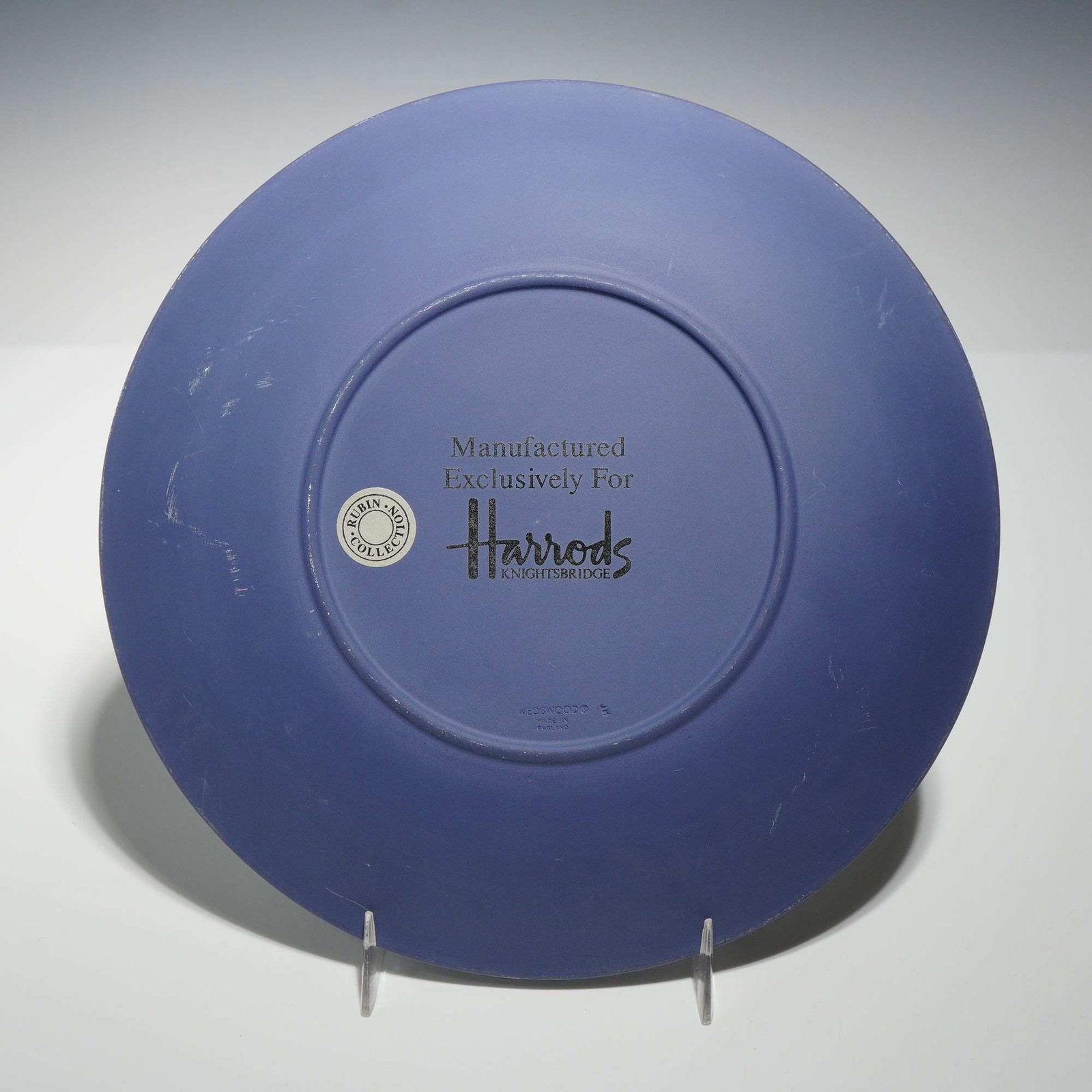 Wedgwood Dark Blue Jasperware Decorative Plate Manufactured Exclusively for Harrods: This decorative plate is crafted from matte dark blue jasperware stoneware with white sprigged bas-relief decoration. Manufactured in England by Wedgwood, the piece was produced as an exclusive item f