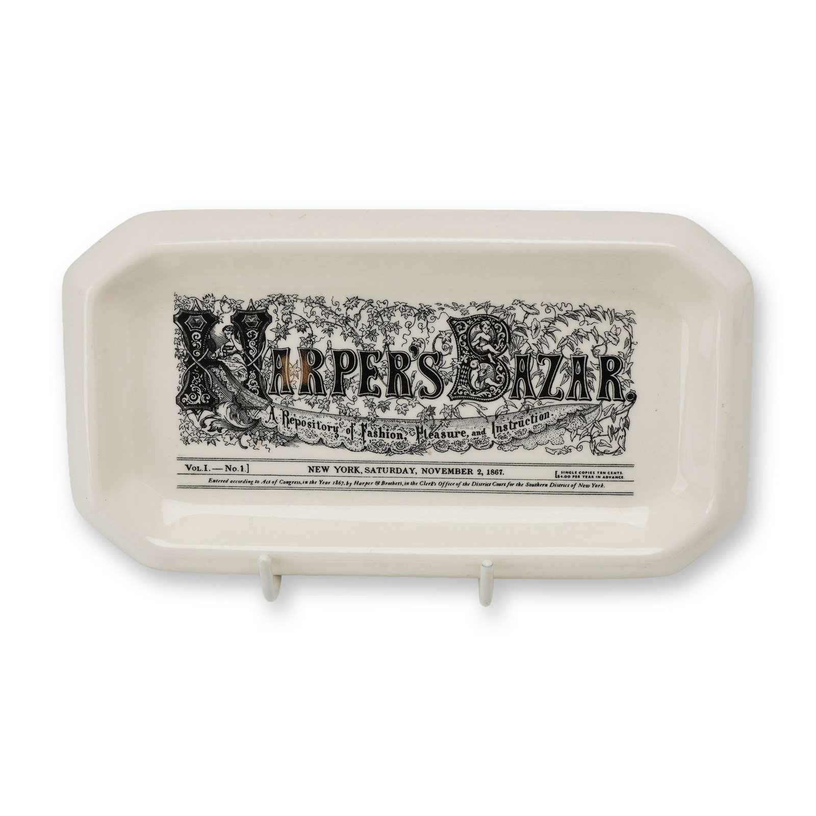 Wedgwood Harpers Bazar 100th Anniversary Commemorative Creamware Trial Tray: A commemorative creamware tray produced by Wedgwood in 1967 to celebrate the centenary of Harpers Bazar magazine. This oblong tray features clipped corners. The interior is decorated with a sepia tran
