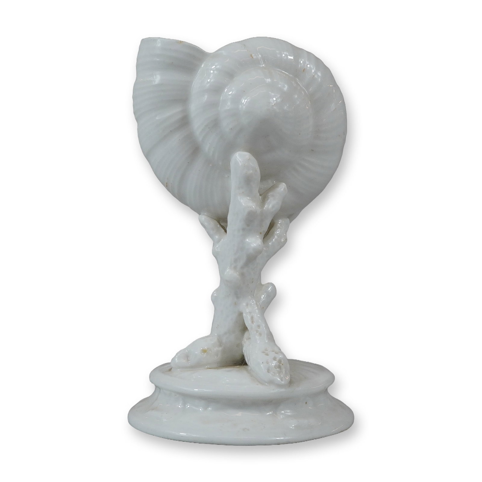 Wedgwood Small White Glazed Ceramic Nautilus Shell and Coral Vase: This Wedgwood decorative ceramic vase is modeled as a nautilus shell supported by a naturalistic stem of branching coral, resting on a circular stepped base with molded shell-like details. The entire 