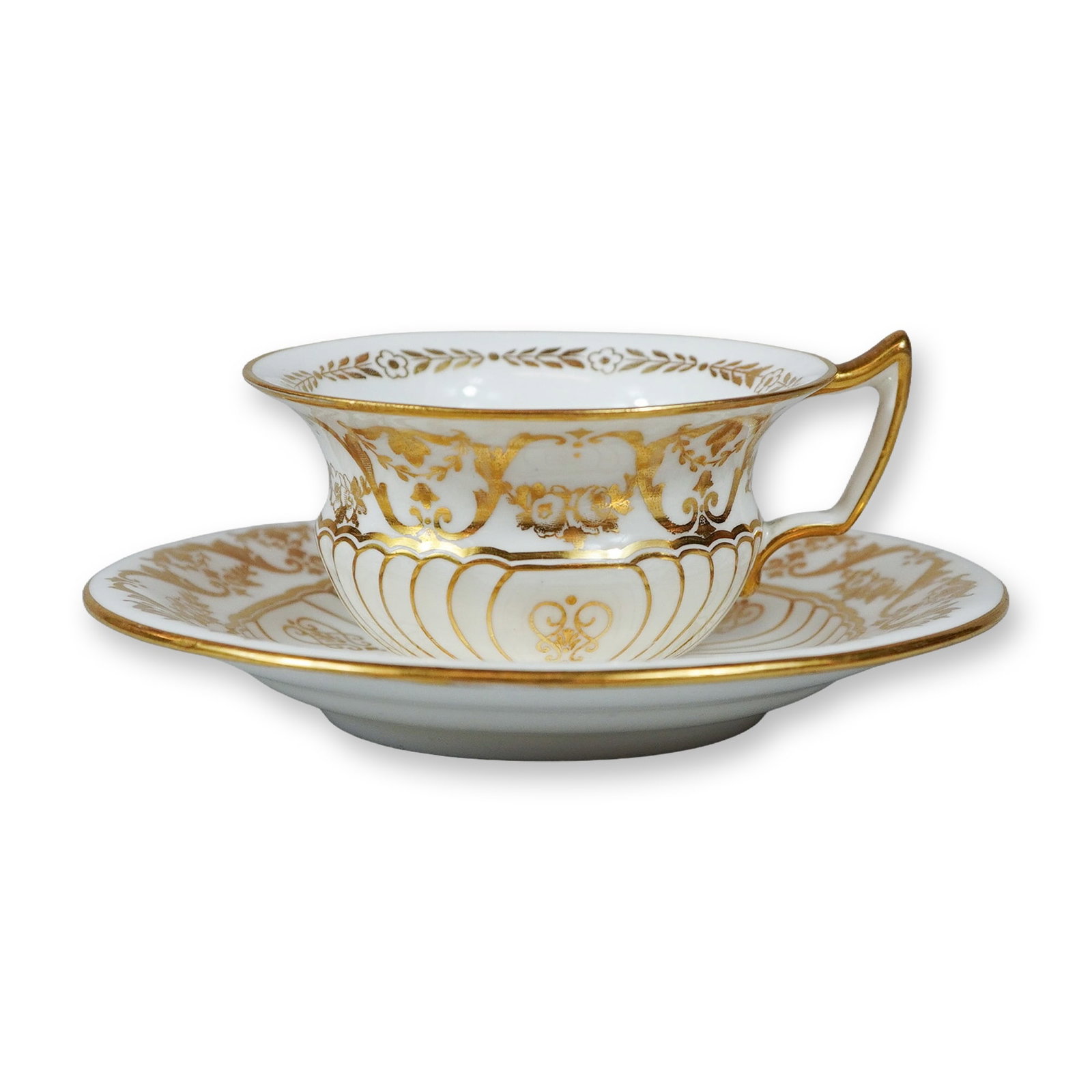 2pc Wedgwood Gilt Bone China Cup and Saucer Set: This Wedgwood fine bone china cup and saucer set features the Pear Etruria shape, characterized by a classic white and gold color scheme. The set is elaborately decorated with heavy gilding that inclu