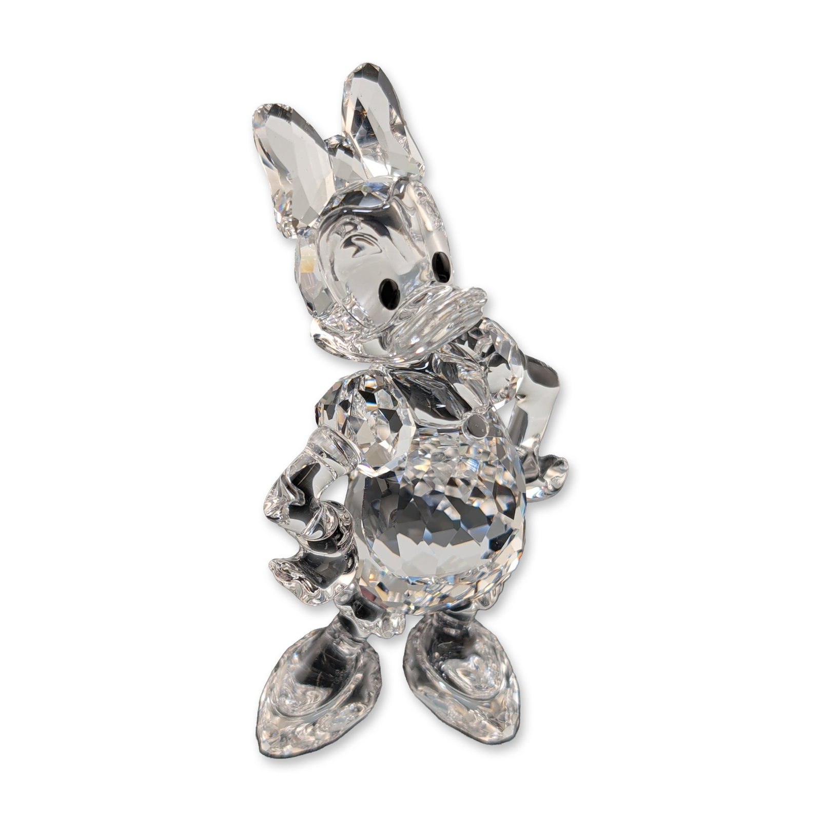 Swarovski Disney Daisy Duck Crystal Figurine: Swarovski crystal figurine depicting the character Daisy Duck. The figure is constructed from clear faceted lead crystal with black crystal eyes, shown in a standing pose with hands positioned on hips