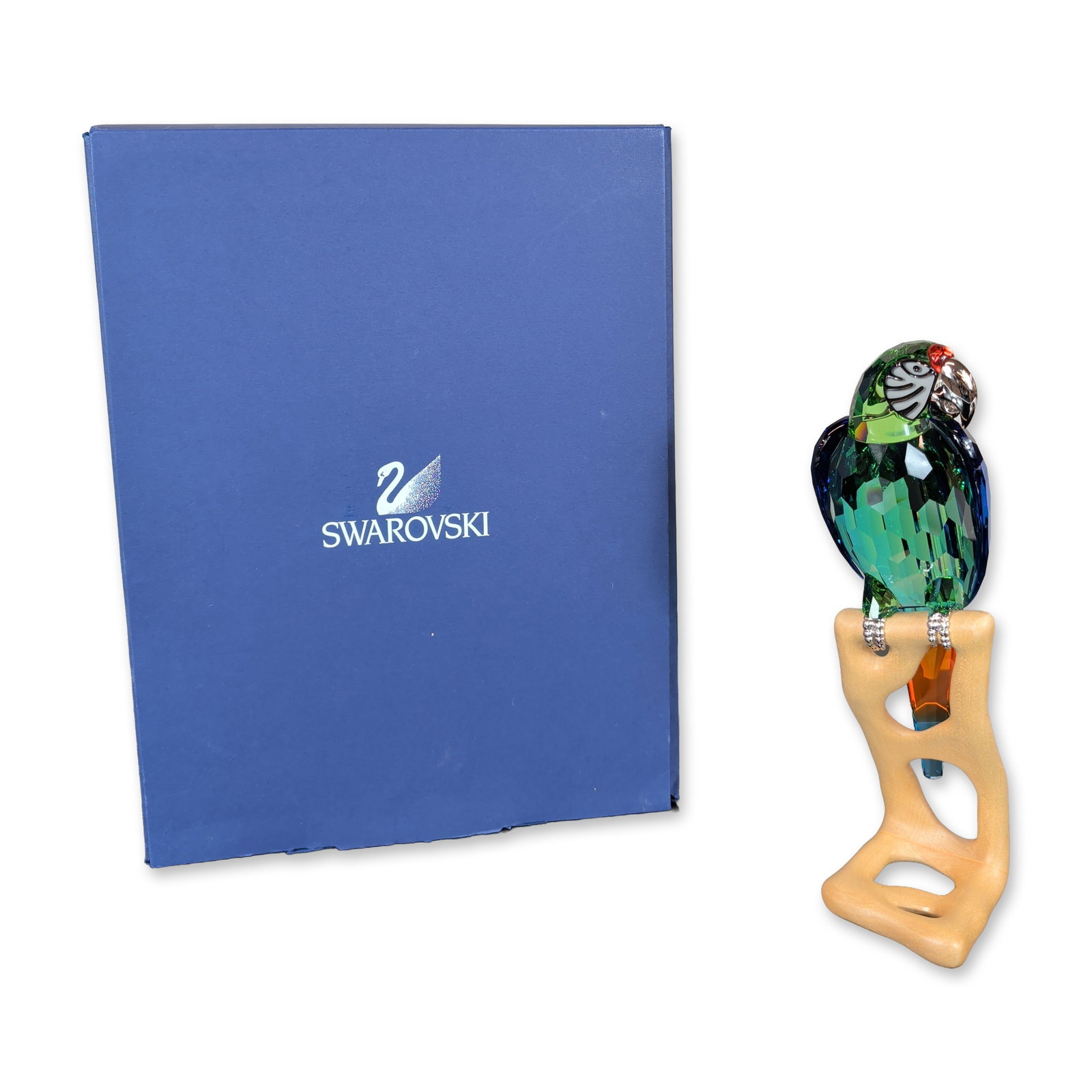 Swarovski Crystal Paradise Birds Green Macaw Figurine: Swarovski Crystal Paradise collection. Green Macaw figurine in faceted multi-colored crystal, featuring a silver-tone metal beak and eye surrounds with feet pave-set with clear crystals. Mounted on a 