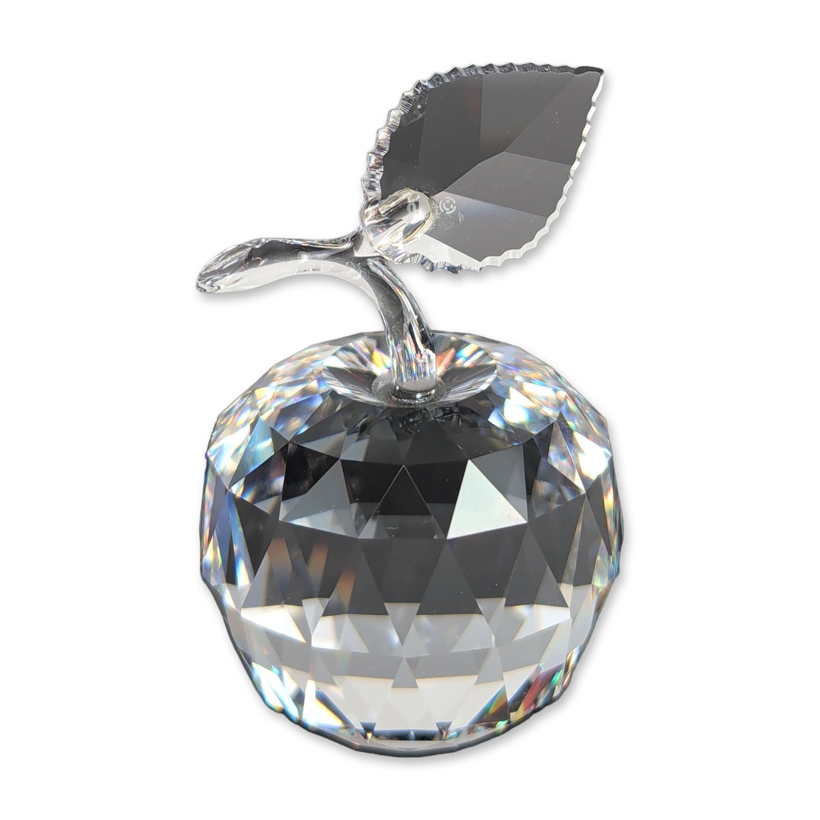 Swarovski Silver Crystal Apple Figurine: Swarovski Austrian lead crystal figurine designed as a multifaceted apple with a smooth applied stem and a single faceted leaf featuring a serrated edge. Etched Swarovski swan logo and copyright symbo