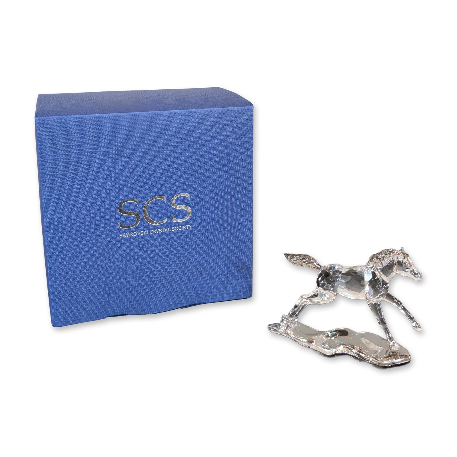 Swarovski SCS Foal Esperanza Figurine: Swarovski SCS Annual Edition 2014 Foal Esperanza figurine in faceted clear lead crystal, featuring a horse in a dynamic rearing pose mounted on an integral textured clear crystal base. The underside o