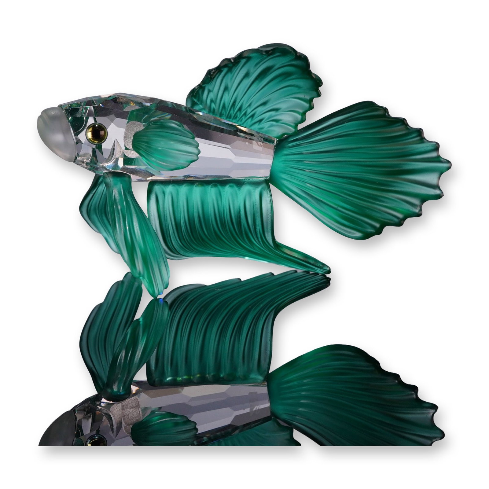 Swarovski Crystal Figurine, Siamese Fighting Fish Green: Swarovski crystal figurine depicting a Siamese fighting fish, also known as a Betta. The piece features a faceted clear crystal body contrasted by satin emerald, green crystal fins and tail. Detailed 