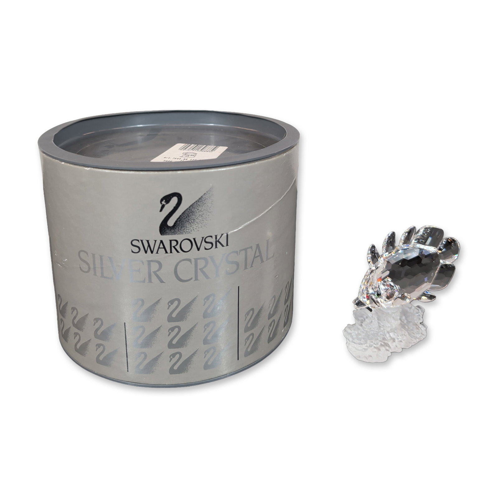 Swarovski Silver Crystal Butterfly Fish Figurine: Swarovski figurine in faceted and frosted lead crystal depicting a Butterfly fish on a coral base. The fish features a faceted clear crystal body with small black crystal eyes, mounted to a textured f