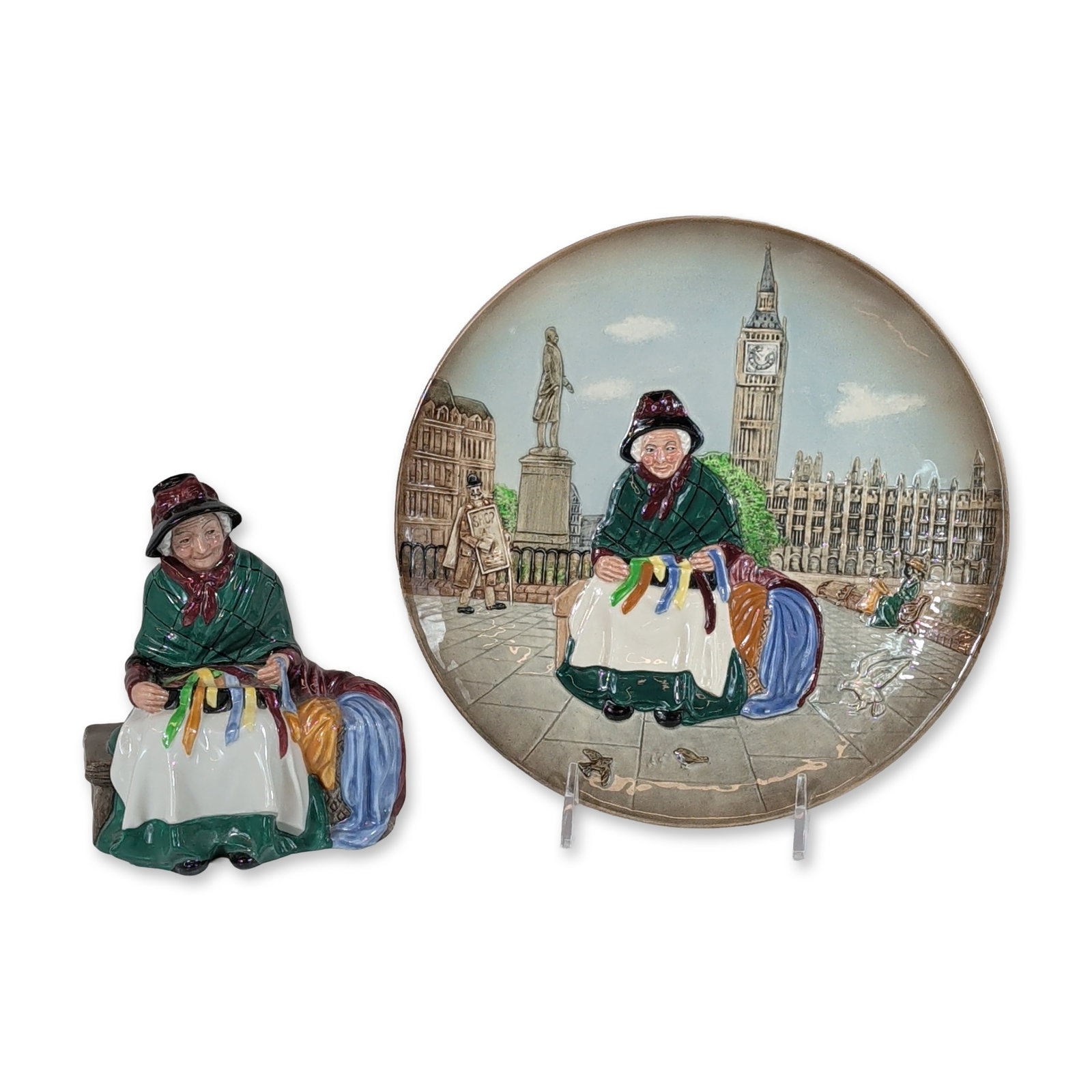2pc Royal Doulton Silks and Ribbons Figurine HN2017 and Relief Plate: Royal Doulton, England. Pair of porcelain pieces from the Silks and Ribbons collection, including one figurine and one relief plate D6663. The HN 2017 figurine depicts a seated elderly female street v