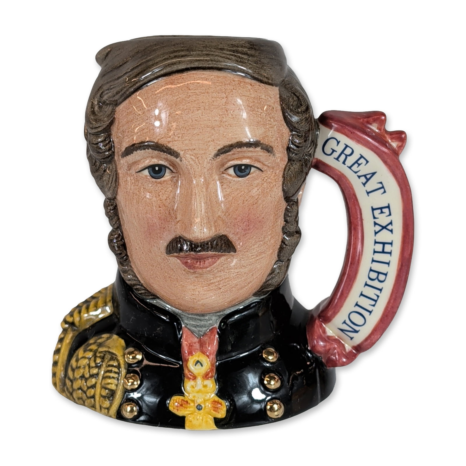 Royal Doulton Prince Albert Small Character Jug D7073: Royal Doulton. Small character jug in hand-decorated glazed ceramic, depicting Prince Albert in black military uniform with gold-toned buttons and epaulettes, featuring a red and yellow medal at the n
