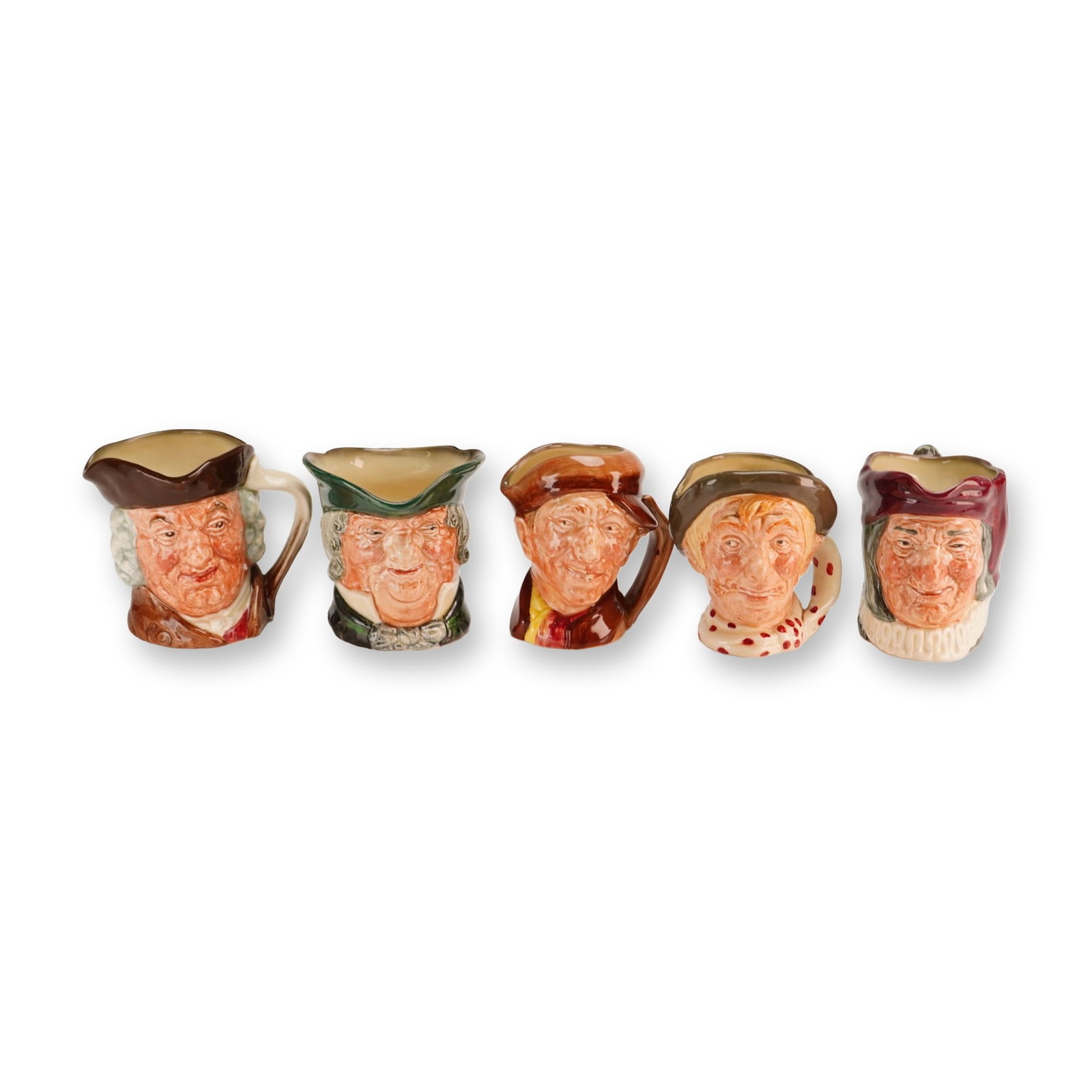 Lot of 5 Royal Doulton Small Character Jugs - Jarge, Simon, Sam Johnson & Others: A collection of five small glazed earthenware character jugs produced by Royal Doulton in England. Each jug is modeled in relief and features hand-painted underglaze polychrome decoration. The group i