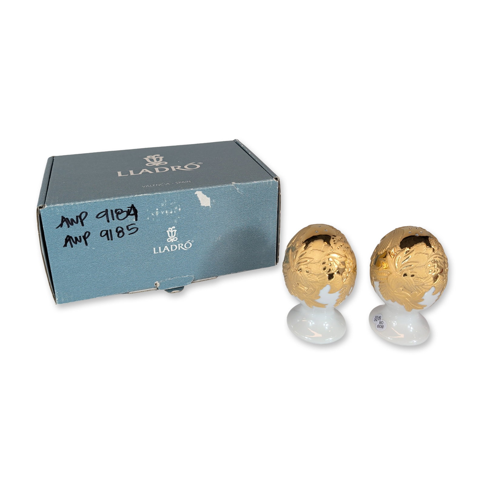 Pair of Lladro Naturofantastic Porcelain Salt and Pepper Shakers 01007943: Lladro porcelain salt and pepper shakers from the Naturofantastic collection, golden colorway. Each shaker features an egg-shaped body atop a flared pedestal base, decorated with textured botanical re