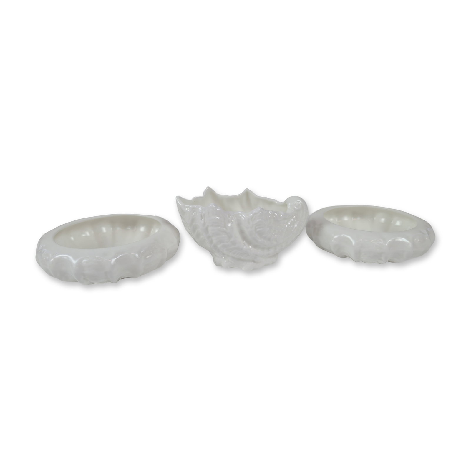 Three Coalport English Bone China Countryware: Featuring embossed leaf designs and a glossy white glaze. The assortment includes one shell-form bowl with a scrolling handle and two circular nut or salt dishes with scalloped rims. Each piece