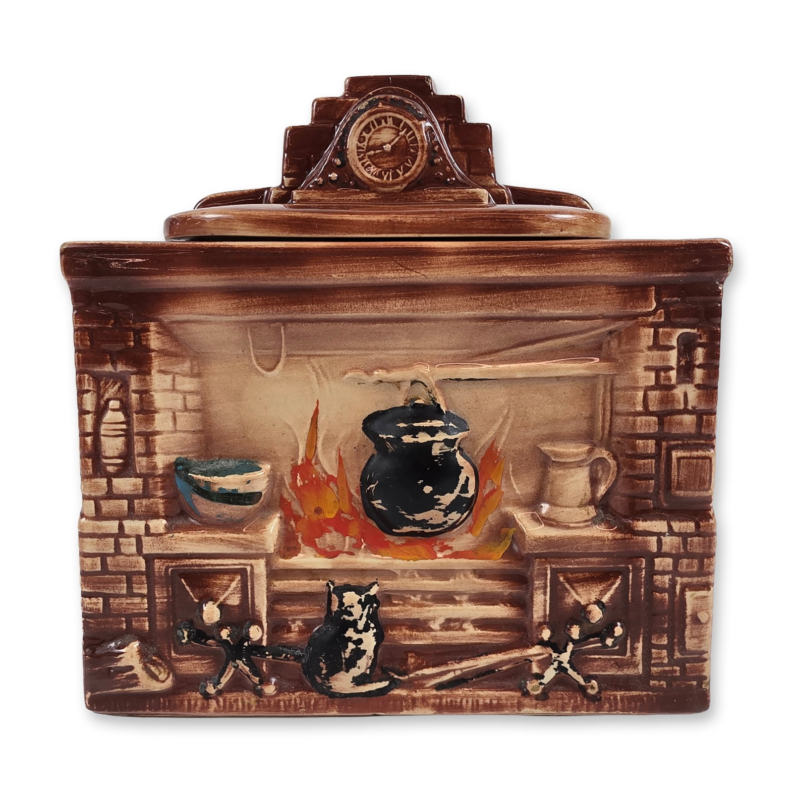 McCoy Fireplace Novelty Cookie Jar: Novelty Colonial Fireplace cookie jar in glazed earthenware. The rectangular body features relief-molded details of a hearth with a cauldron over an open fire and a seated cat. The removable lid is
