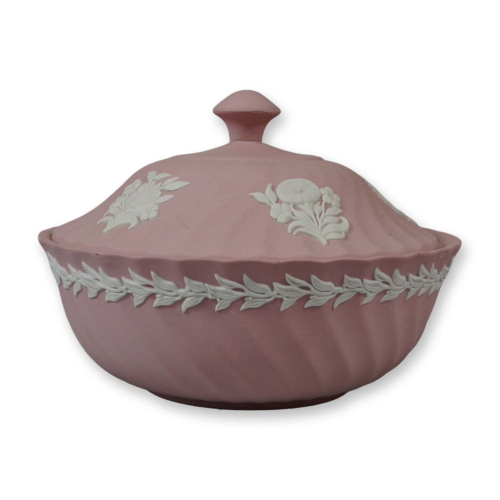 Wedgwood Pink Jasperware Spiral Fluted Covered Bowl: A Wedgwood jasperware covered bowl in a pink colorway with white relief decorations. The circular bowl and matching domed lid feature a diagonal spiral flute or swirled texture. The lid is decorated w