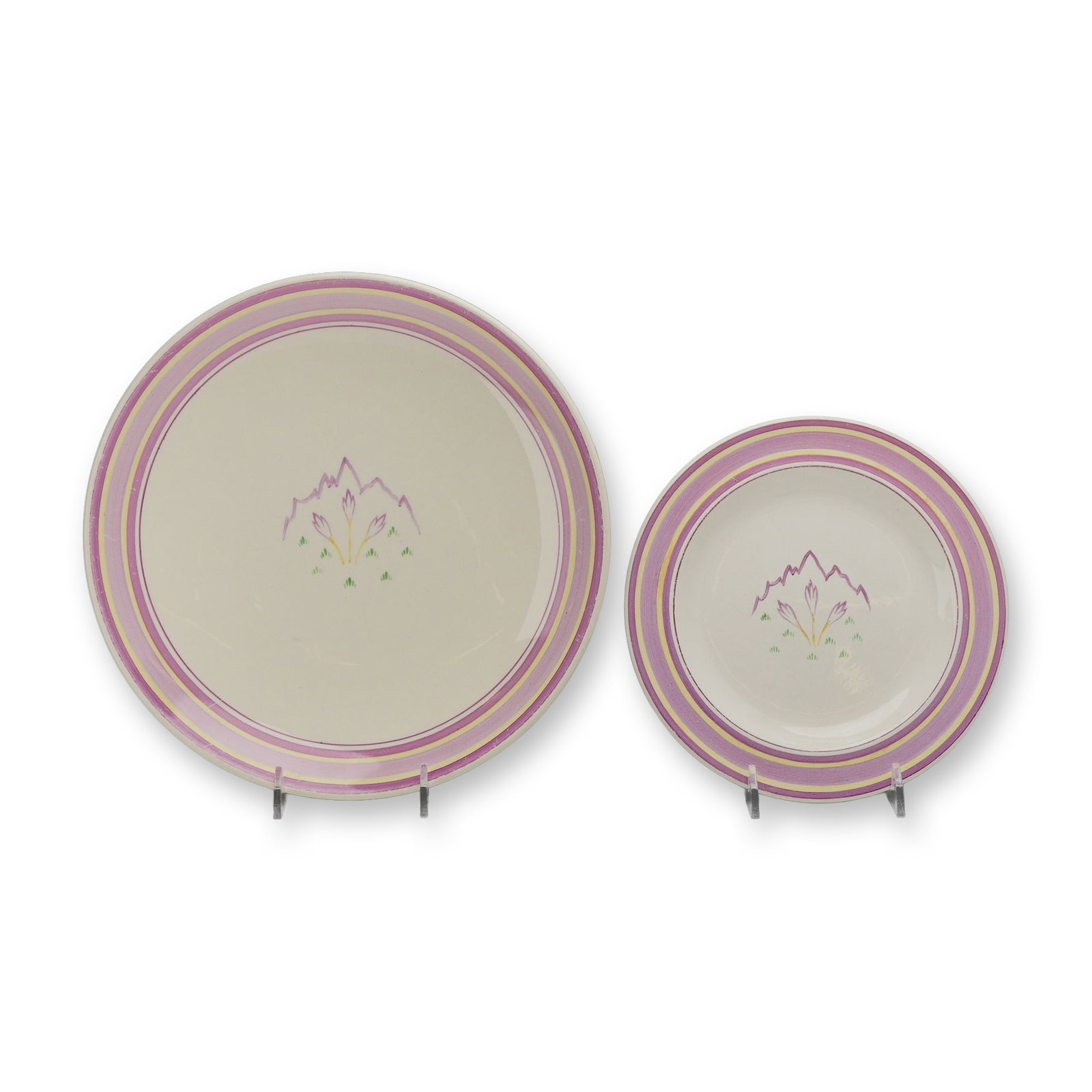 Two Wedgwood Earthenware Dresden Spray Pattern Plates, c.1931: The set includes one larger luncheon or dinner plate and one smaller bread and butter plate, both featuring cream-colored earthenware bodies. Each plate is decorated with a hand-painted Art Deco cente