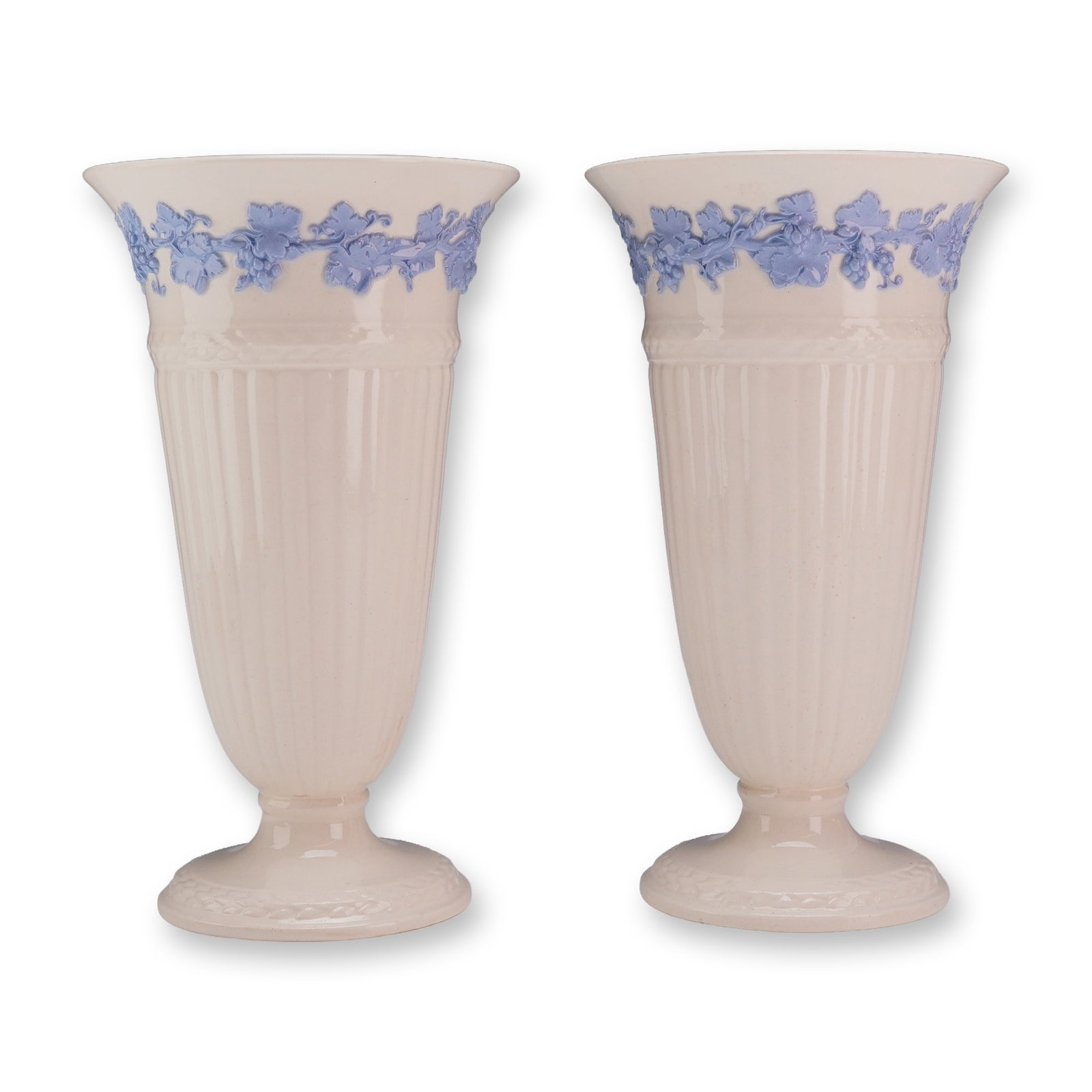 Pair of Wedgwood Embossed Queen's Ware Vases: This pair of Wedgwood Embossed Queen's Ware vases is crafted from cream-colored earthenware, a material historically designated as Queen's Ware by the manufacturer. Each vase is designed with a flared