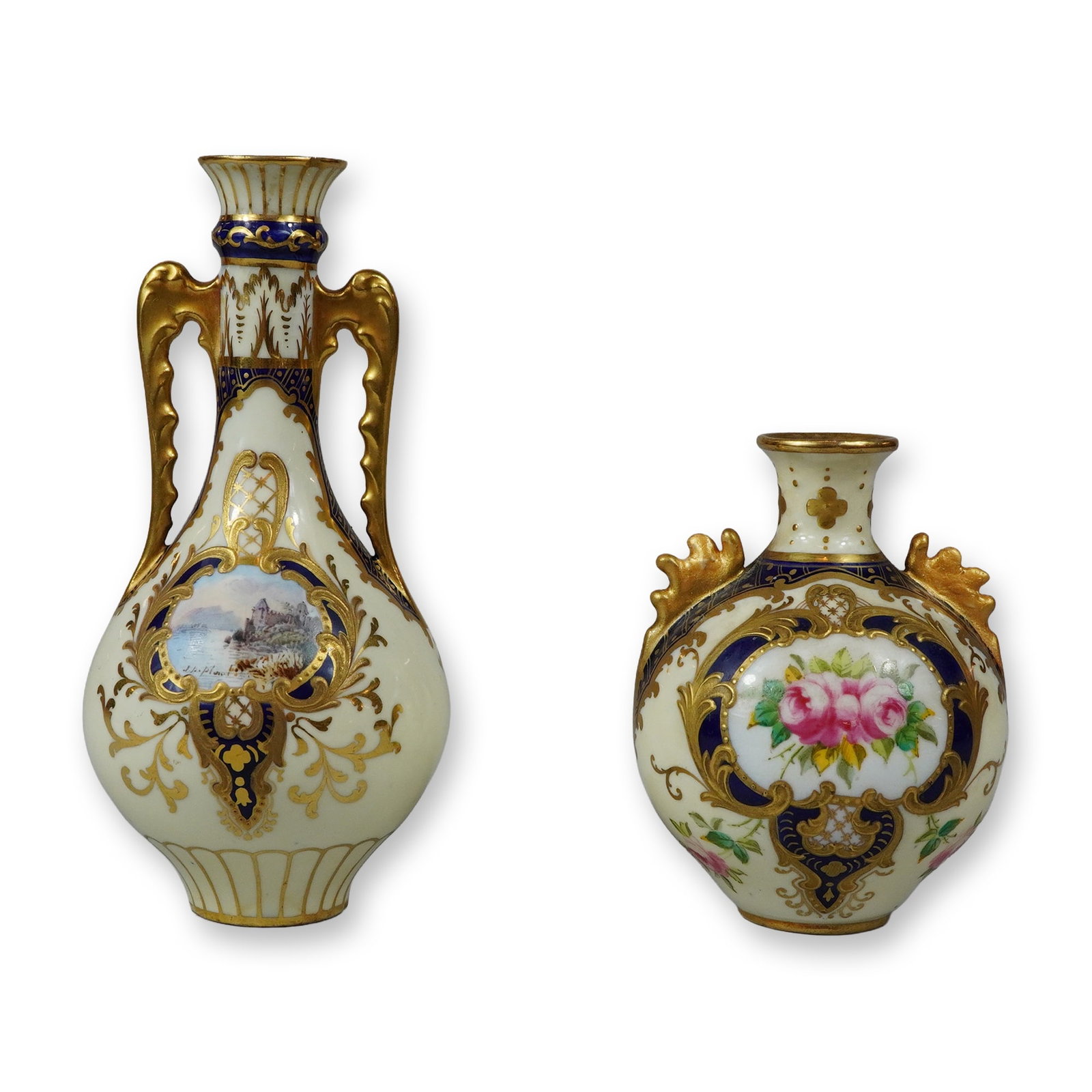 2pc Wedgwood Small Porcelain Gilded Vases: This lot features two miniature ceramic cabinet vases produced by Josiah Wedgwood and Sons Ltd in England. The first vase is an amphora-style vessel with twin high-arched gilded handles, a fluted neck