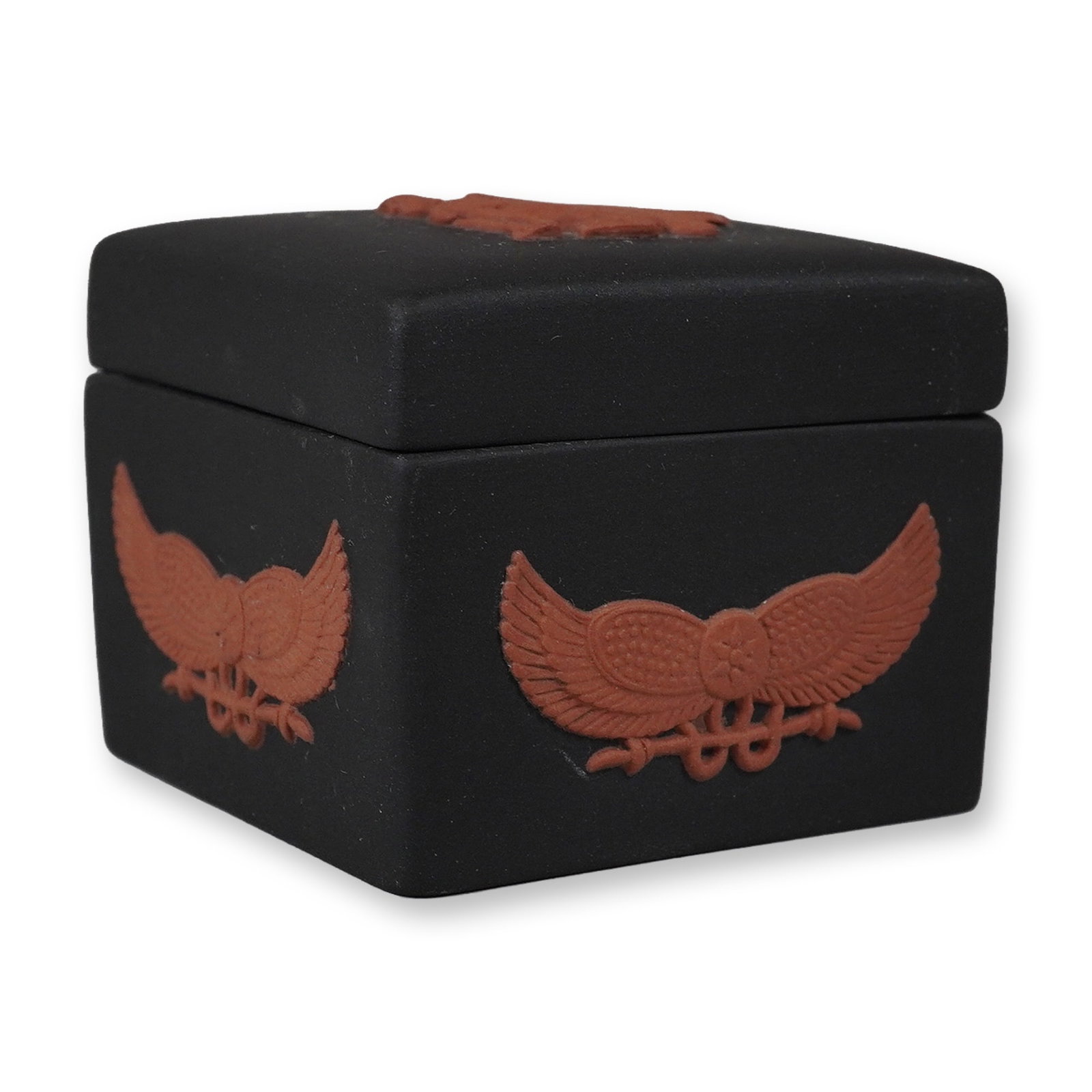 Wedgwood Egyptian Collection Black Jasperware and Terracotta Square Trinket Box: This square lidded trinket box is part of the Wedgwood Egyptian Collection. The piece is crafted from matte black jasperware featuring applied terracotta-colored bas-relief decoration. The lid is ador