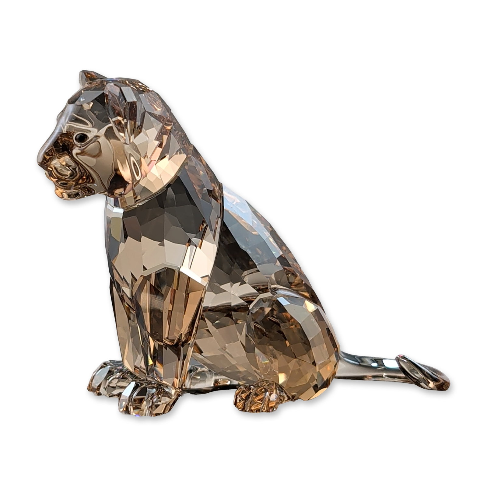 Swarovski Crystal SCS 2016 Annual Edition Figurine, Lion Cub: Swarovski faceted crystal figurine depicting a seated lion cub, crafted in light brown crystal with a warm amber tint and a clear curved crystal tail. The piece features a laser-etched Swarovski swan 