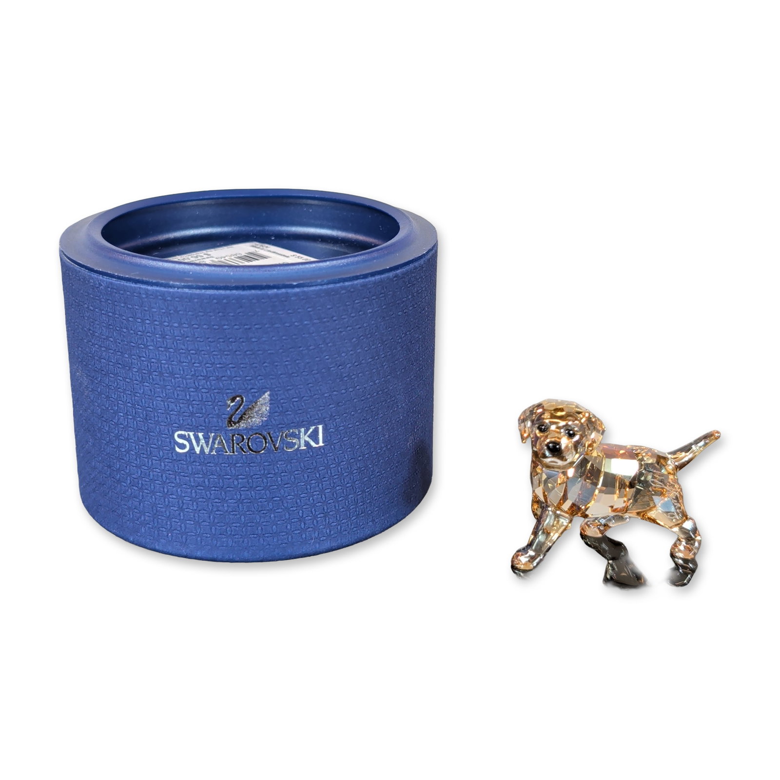 Swarovski Crystal Golden Retriever Puppy Figurine: Swarovski Puppy figurine in faceted light amber crystal, depicted in a playful crouching pose. The piece features black crystal accents for the eyes and nose. Accompanied by the original cylindrical p