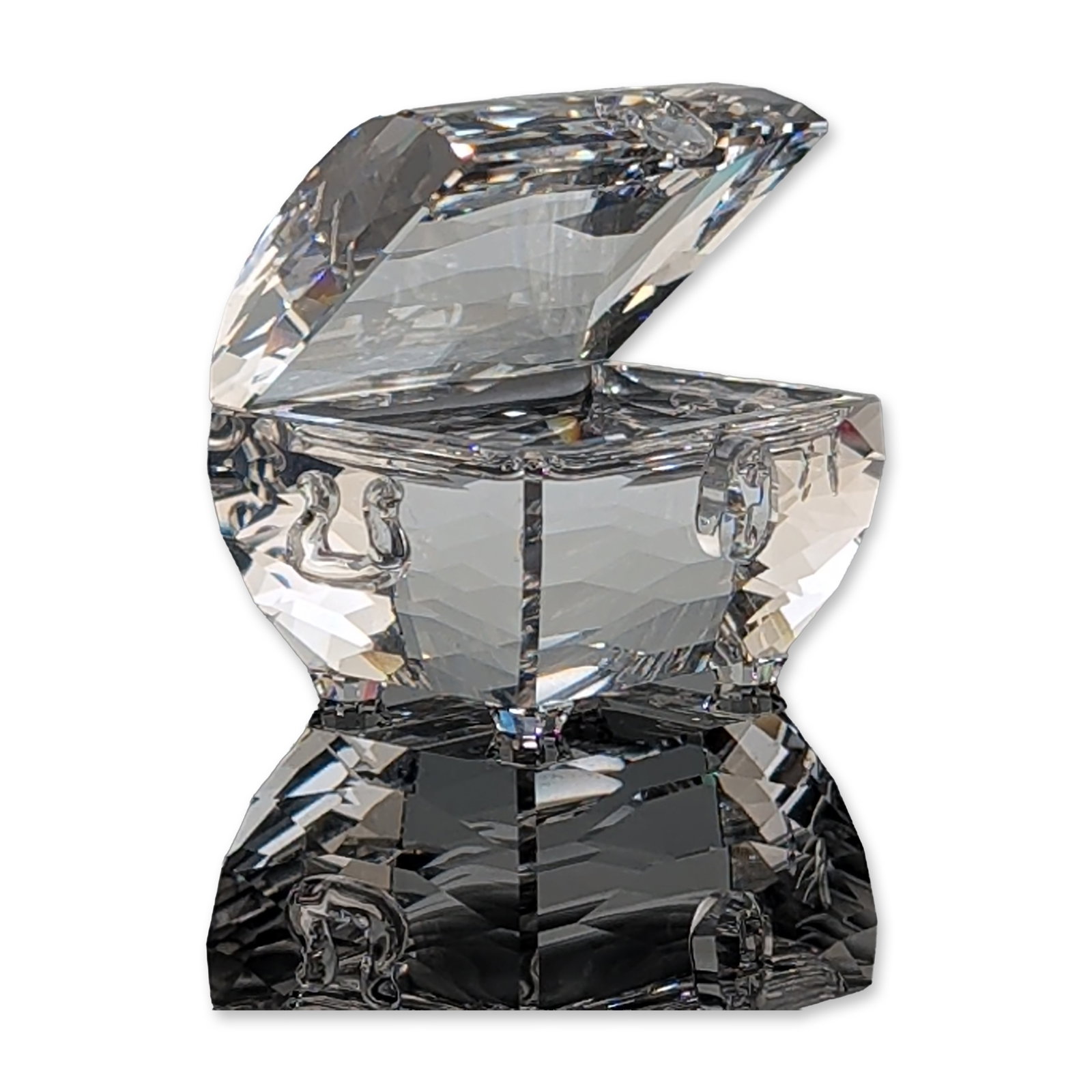 Swarovski Faceted Crystal Treasure Chest Figurine: Swarovski crystal figurine in the form of an open treasure chest. The piece is crafted from clear, highly faceted lead crystal. It features the etched Swarovski swan logo and copyright symbol on the b
