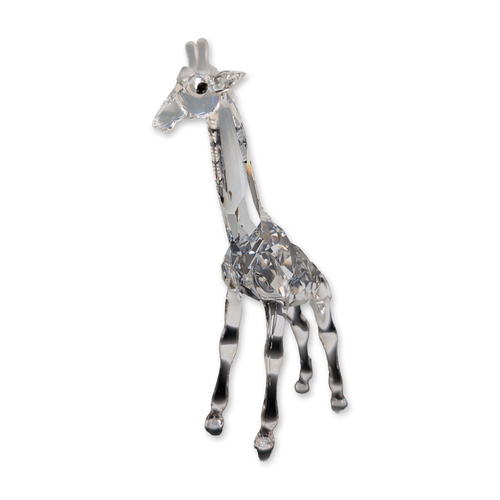 Swarovski Crystal Figurine, Baby Giraffe: Swarovski Baby giraffe figurine in faceted and molded clear lead crystal, part of the Silver Crystal collection. The figure features a multifaceted body for light refraction, with smooth sculpted surf