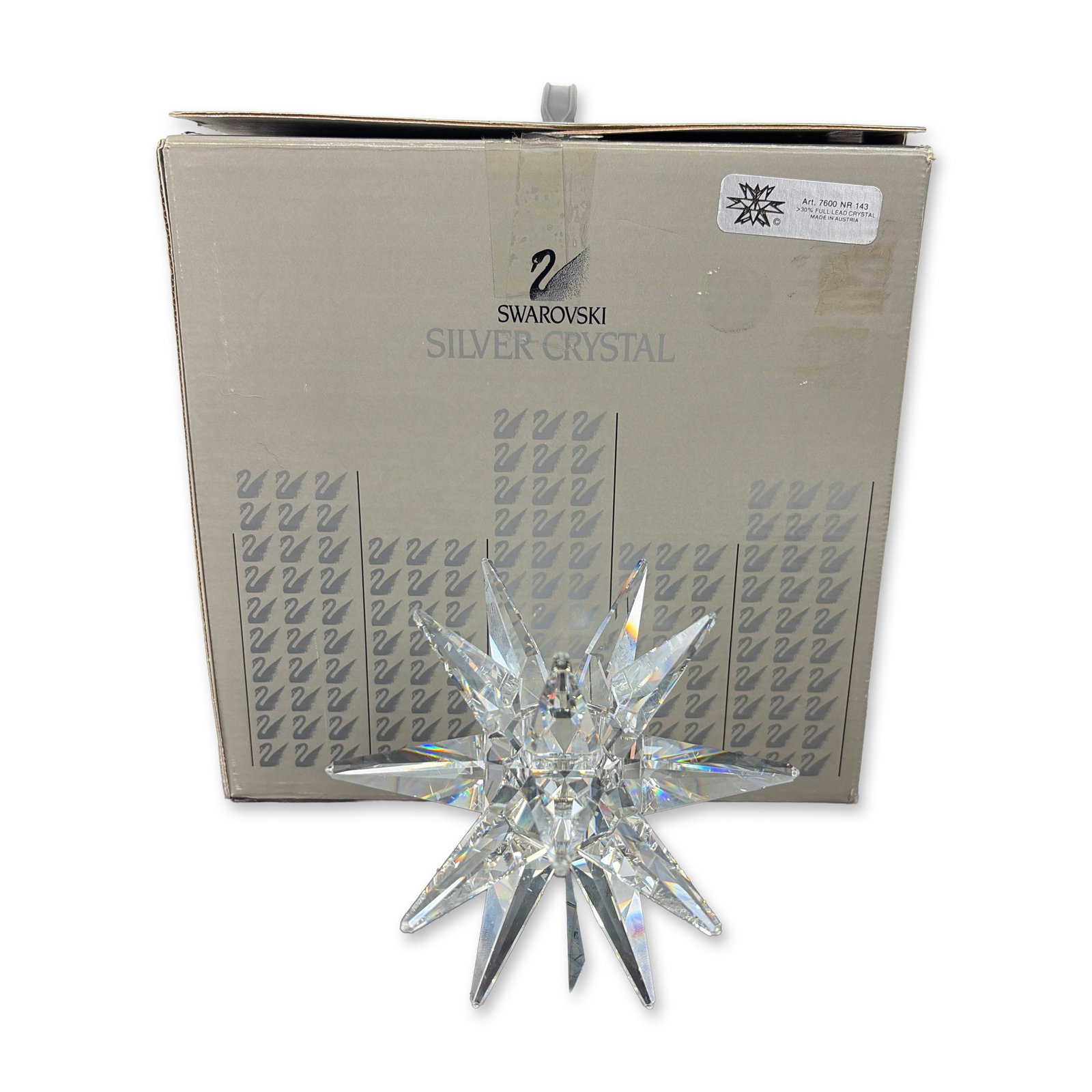 Swarovski Silver Crystal Star Candle Holder: This faceted lead crystal piece showcases a multi-pointed star design with a central circular candle well. One facet is etched with the manufacturers swan logo and a copyright symbol. It is made in Au