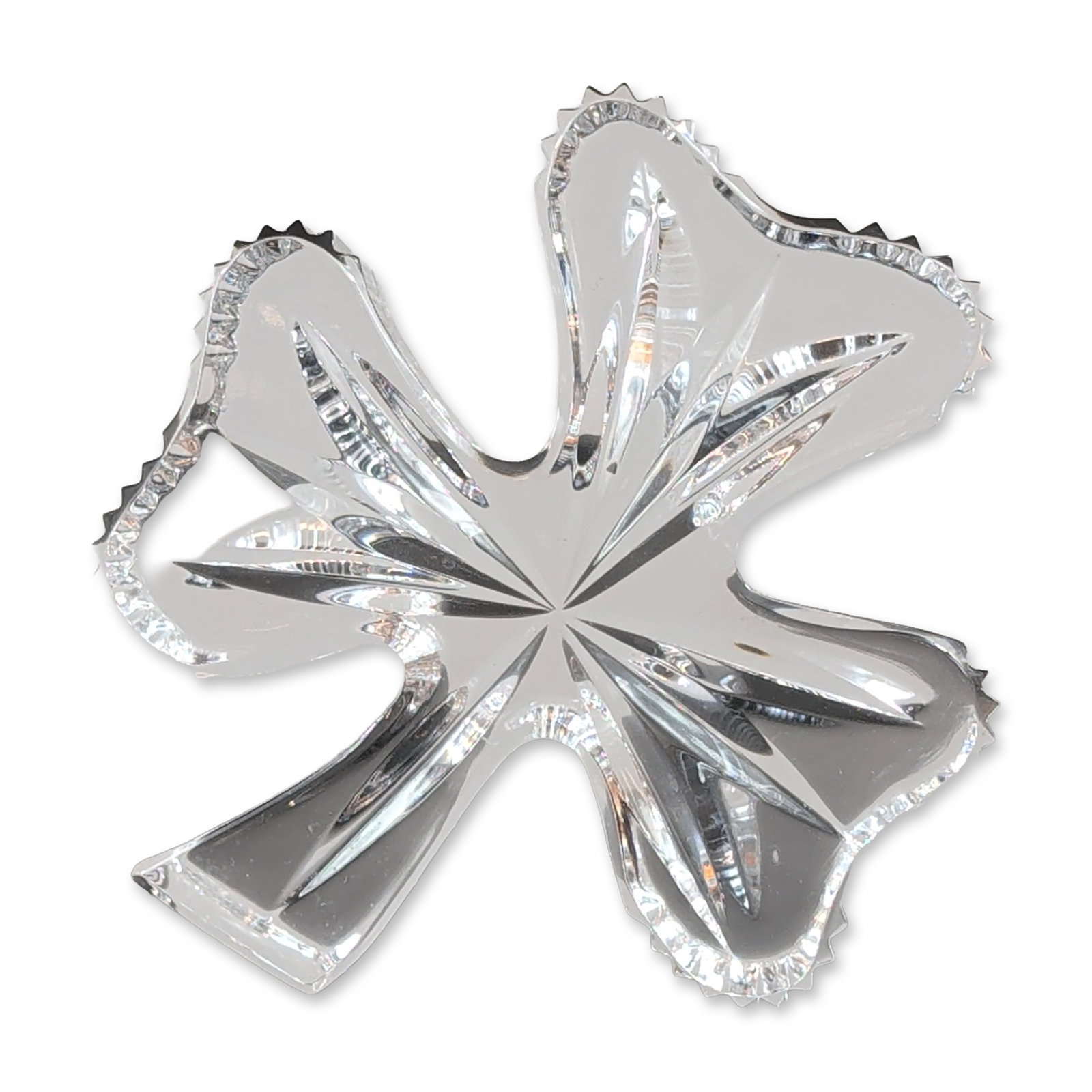 Waterford Crystal Shamrock Paperweight: Waterford lead crystal paperweight in a stylized shamrock form, featuring deep linear faceted cuts and a central starburst motif with textured, ridged edges. The base is signed with an acid-etched Wat
