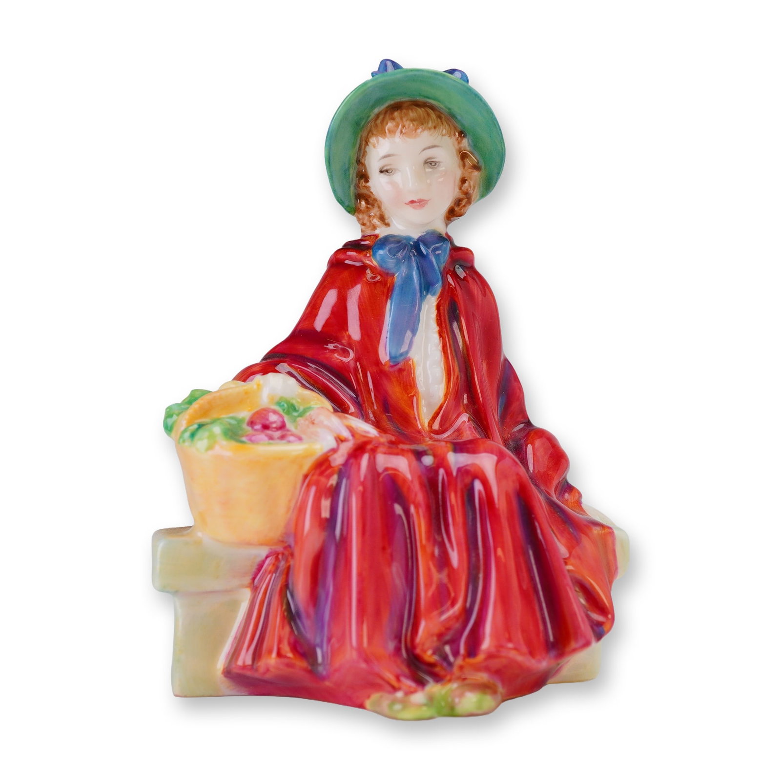 Royal Doulton Bone China Figurine Linda HN2106: A Royal Doulton Bone China Figurine, Linda (HN2106), depicting a woman in a red cape and green hat, marked COPR 1952. Dimensions: 3.25"L x 2.75"W x 4.75"H Weight: 8.10oz