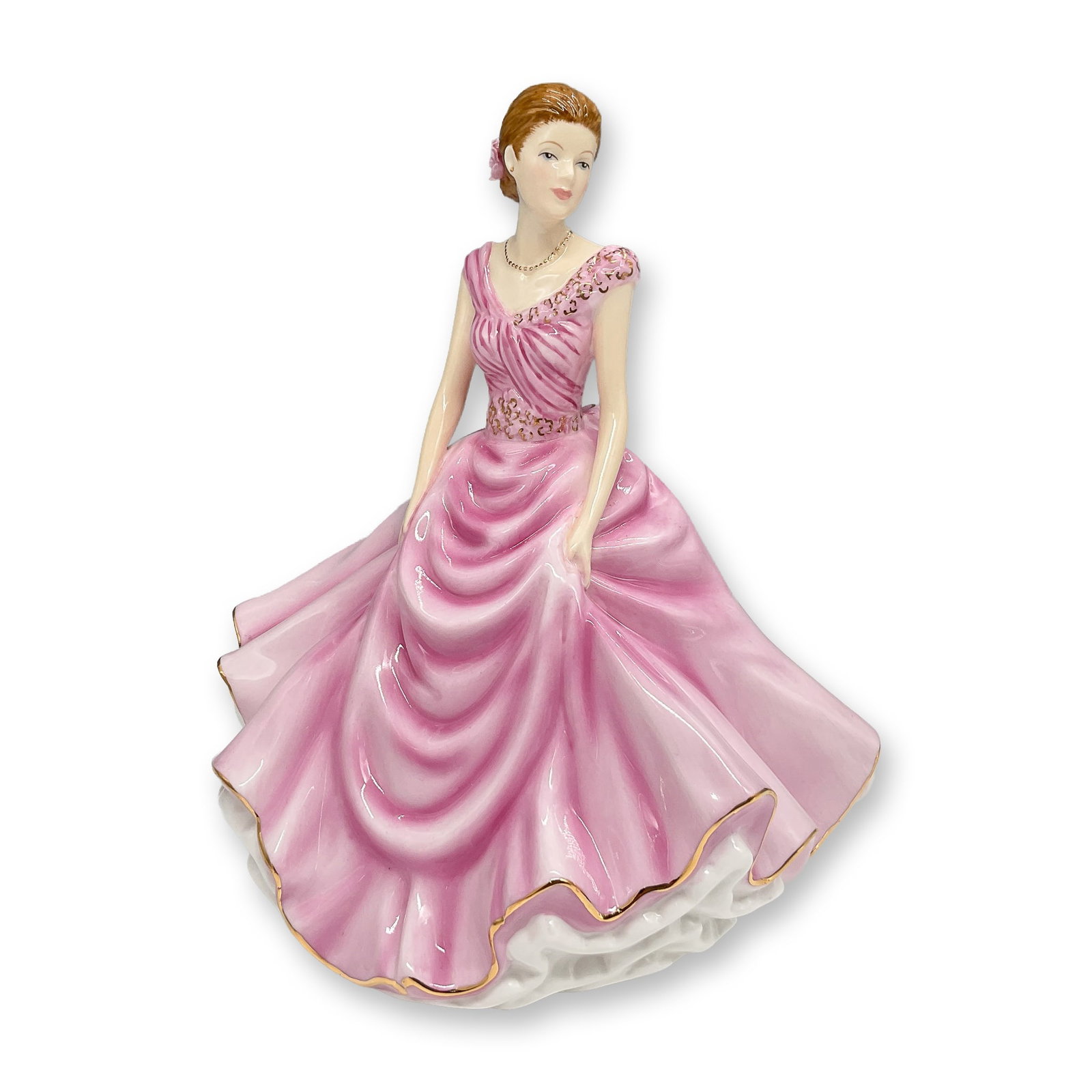 Royal Doulton Figurine, Donna HN5590: Royal Doulton porcelain figurine Donna, Petite Figure of the Year 2013, HN5590. Elegantly hand-decorated in bone china, this figurine features a woman in a flowing pink gown with gold trim, adorned wi