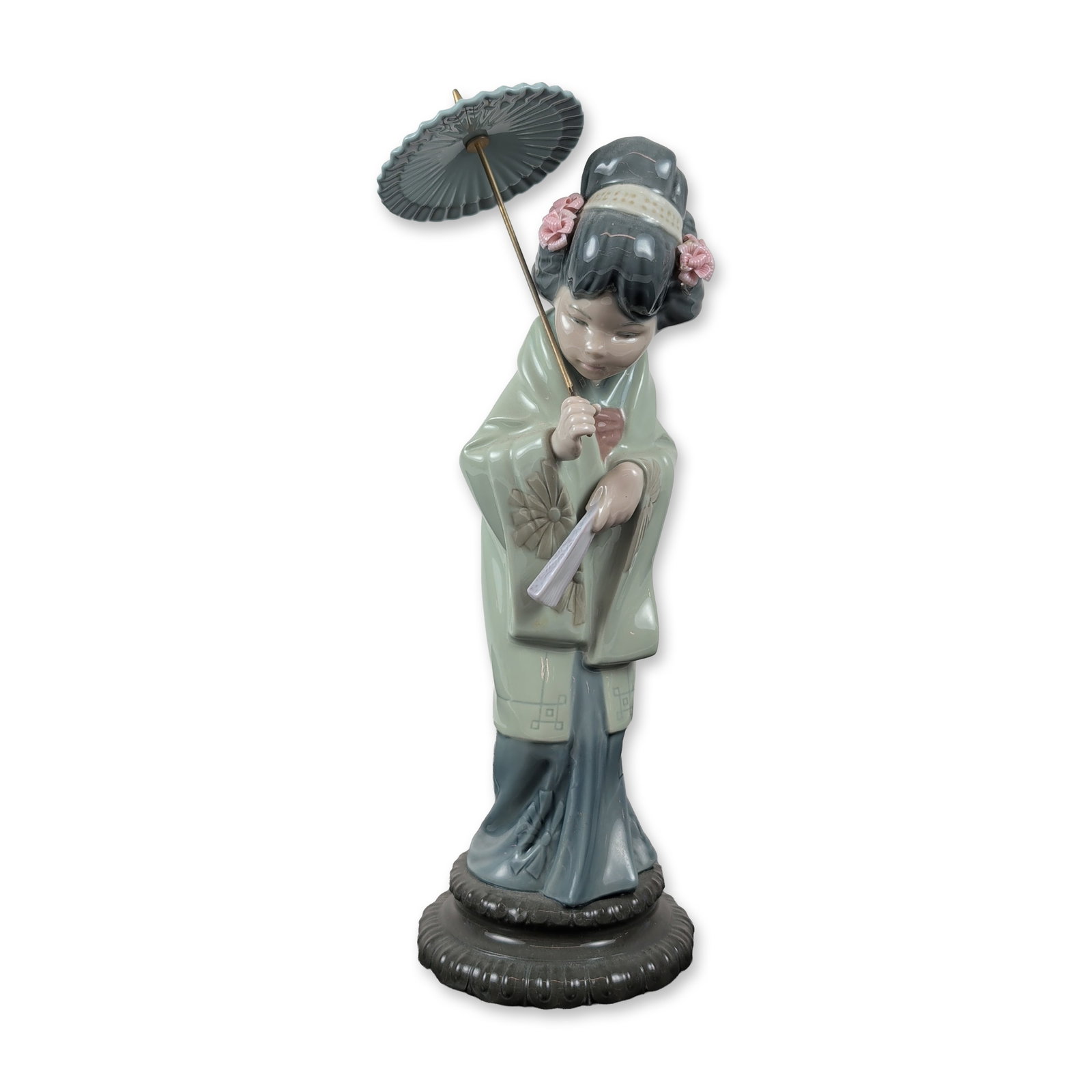 Lladro Porcelain Figurine Oriental Spring 1004988: Lladro, Spain. Glazed porcelain figurine titled Oriental Spring, model number 4988. The piece depicts a young Japanese woman in a traditional light green and blue kimono, modeled in a bowing pose. She