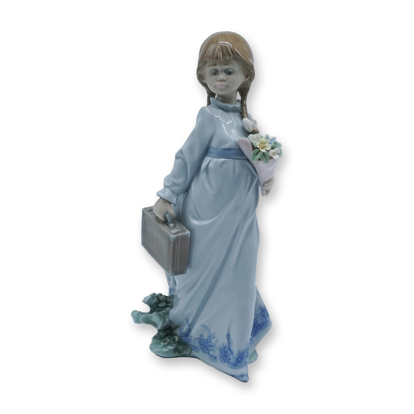 Lladro Porcelain Figurine, School Days 1007604: Charming Lladro porcelain figurine titled School Days (1007604), depicting a young girl with braided hair holding a bouquet and a suitcase, rendered in soft pastel tones with delicate floral detail, t