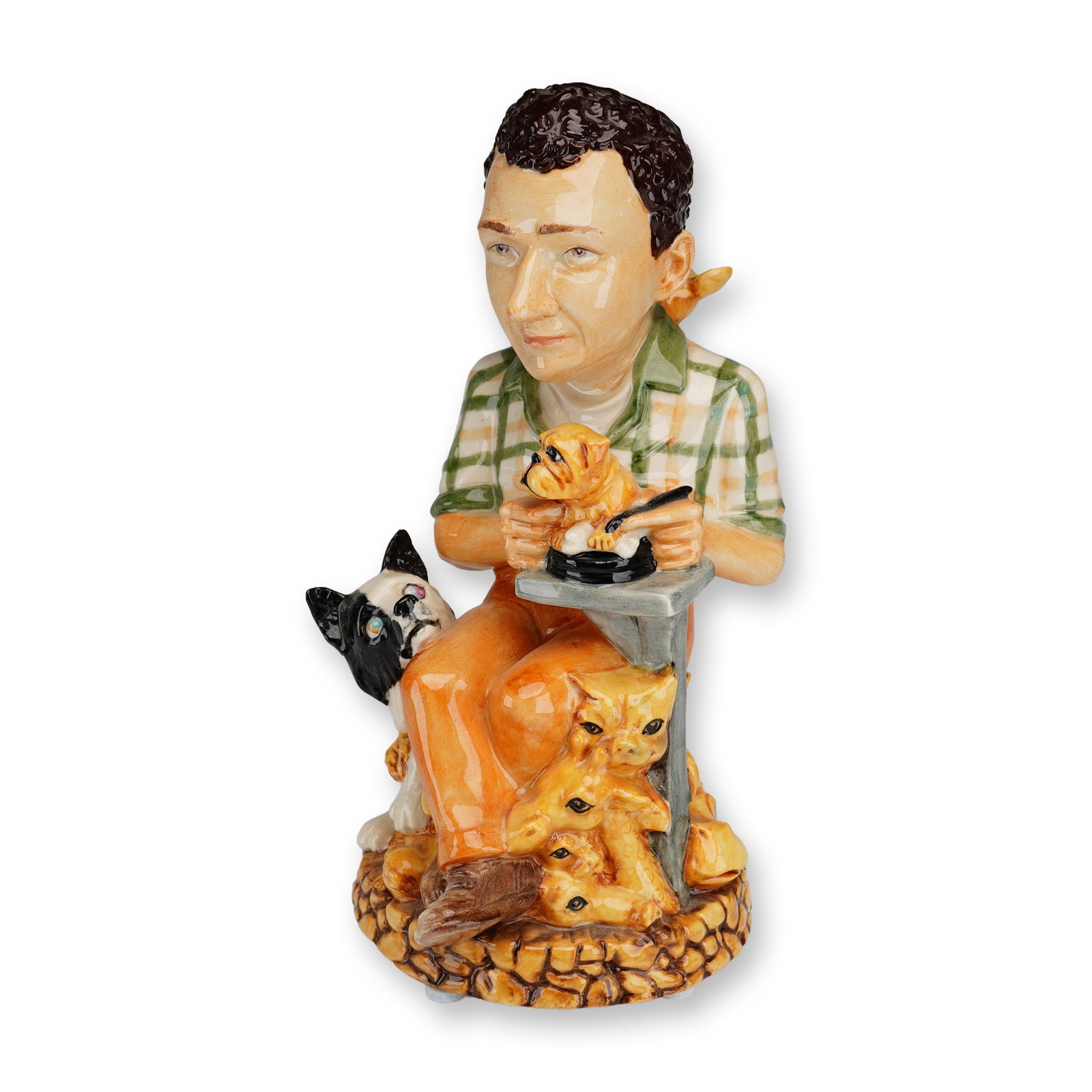 Kevin Francis Harmony Kingdom Limited Edition Character Jug, Peter Calvesbert: A hand-painted ceramic character jug depicting Peter Calvesbert, the principal sculptor for Harmony Kingdom. The subject is portrayed seated at a workbench in a green and white plaid shirt and orange 