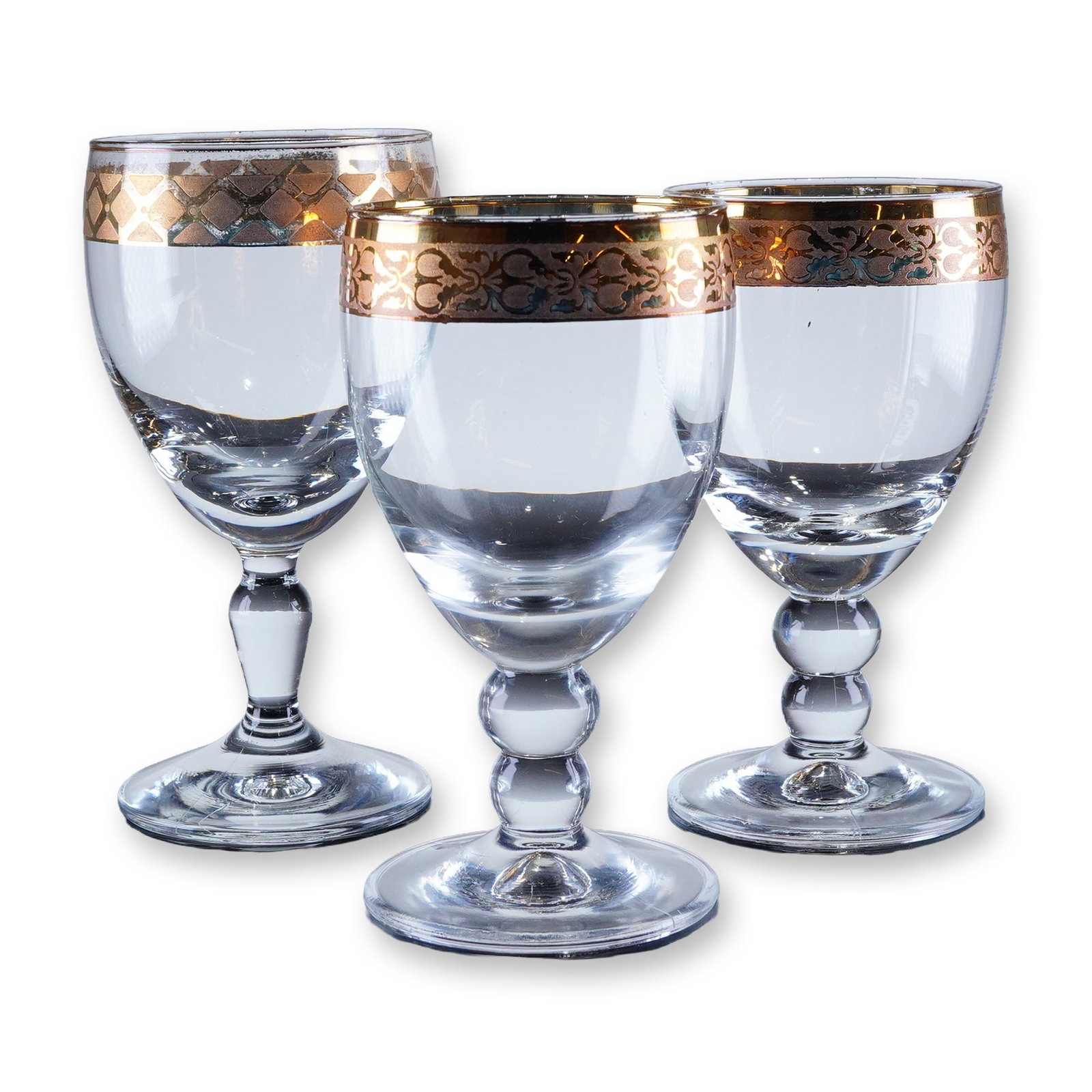 3pc Gold Rim Crystal Wine Glasses: A trio of stemmed drinking glasses, featuring heavy gold-gilt decoration applied to the rim and upper bowl section. The decoration consists of a solid gold band at the rim, which two glasses display