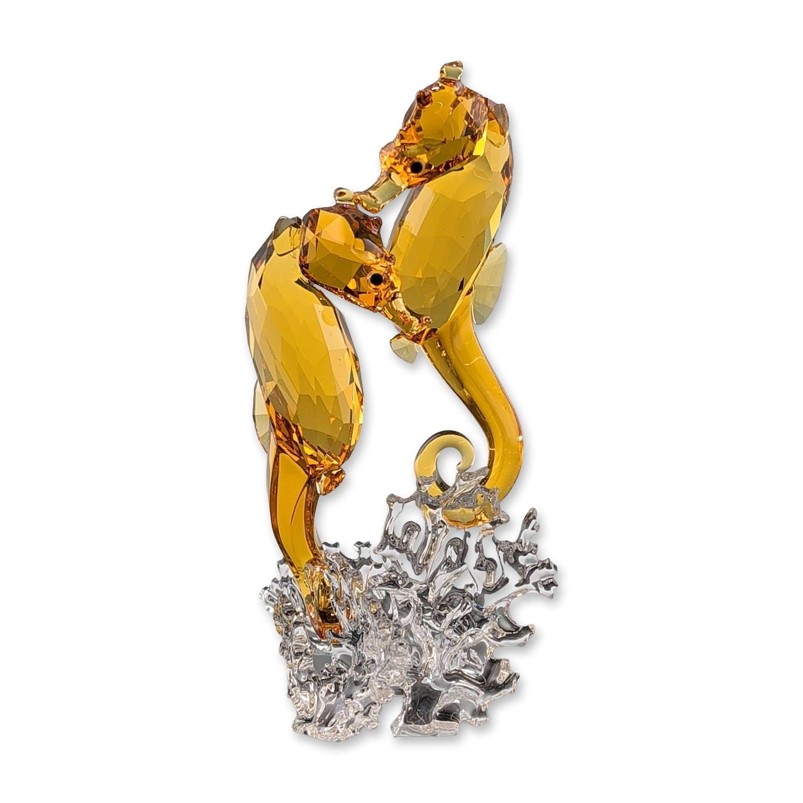 Swarovski Crystal Seahorse Couple Figurine: Swarovski figurine depicting a seahorse couple in faceted amber-toned and clear crystal. The piece features two seahorses with dark crystal eyes, mounted on a textured clear crystal base designed to r