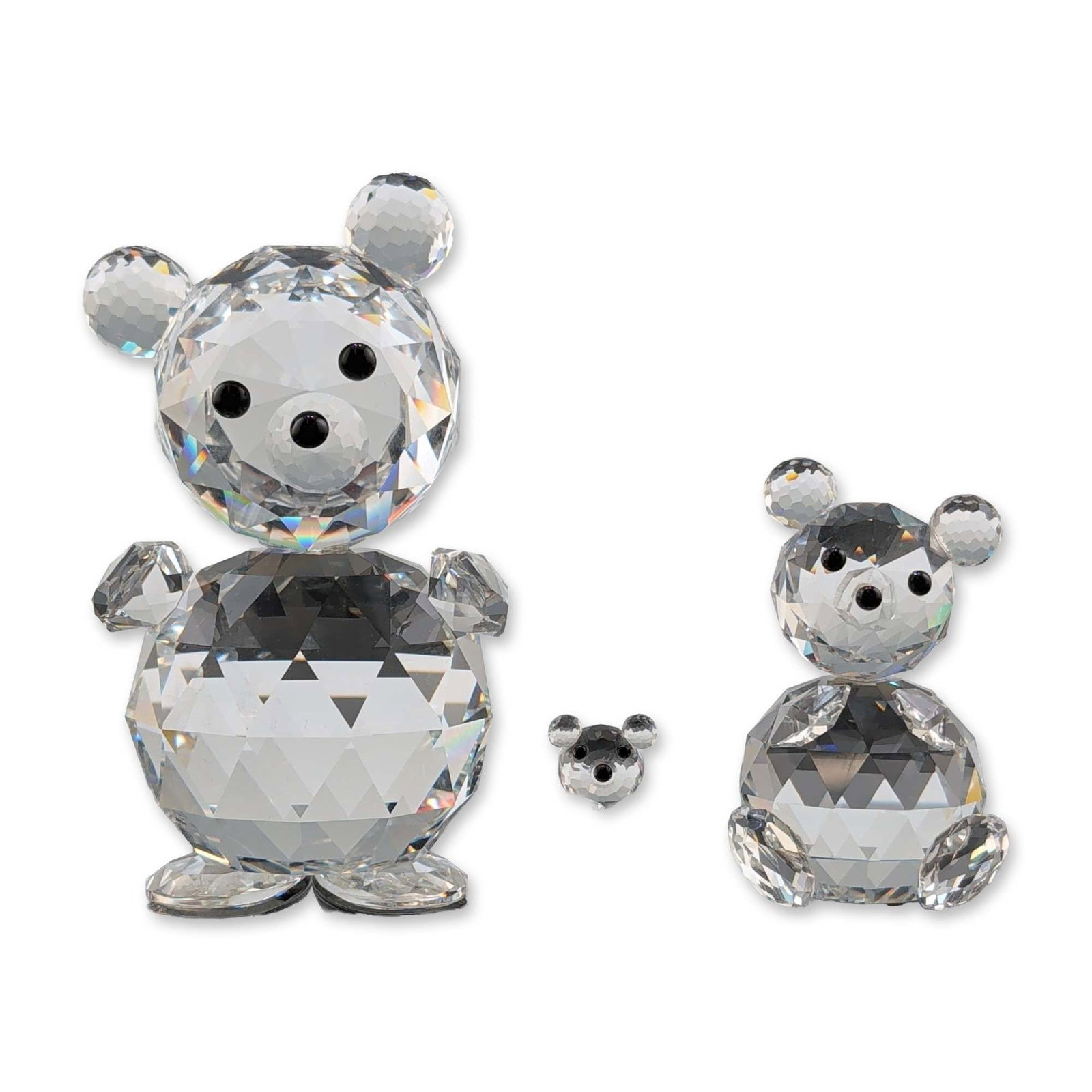 Trio of Swarovski Crystal Bear Figurines: Three Swarovski faceted crystal bear figurines, including a large bear with a tilted head, a medium standing bear, and a small cub. Each piece is constructed from clear faceted crystal with jet-colore