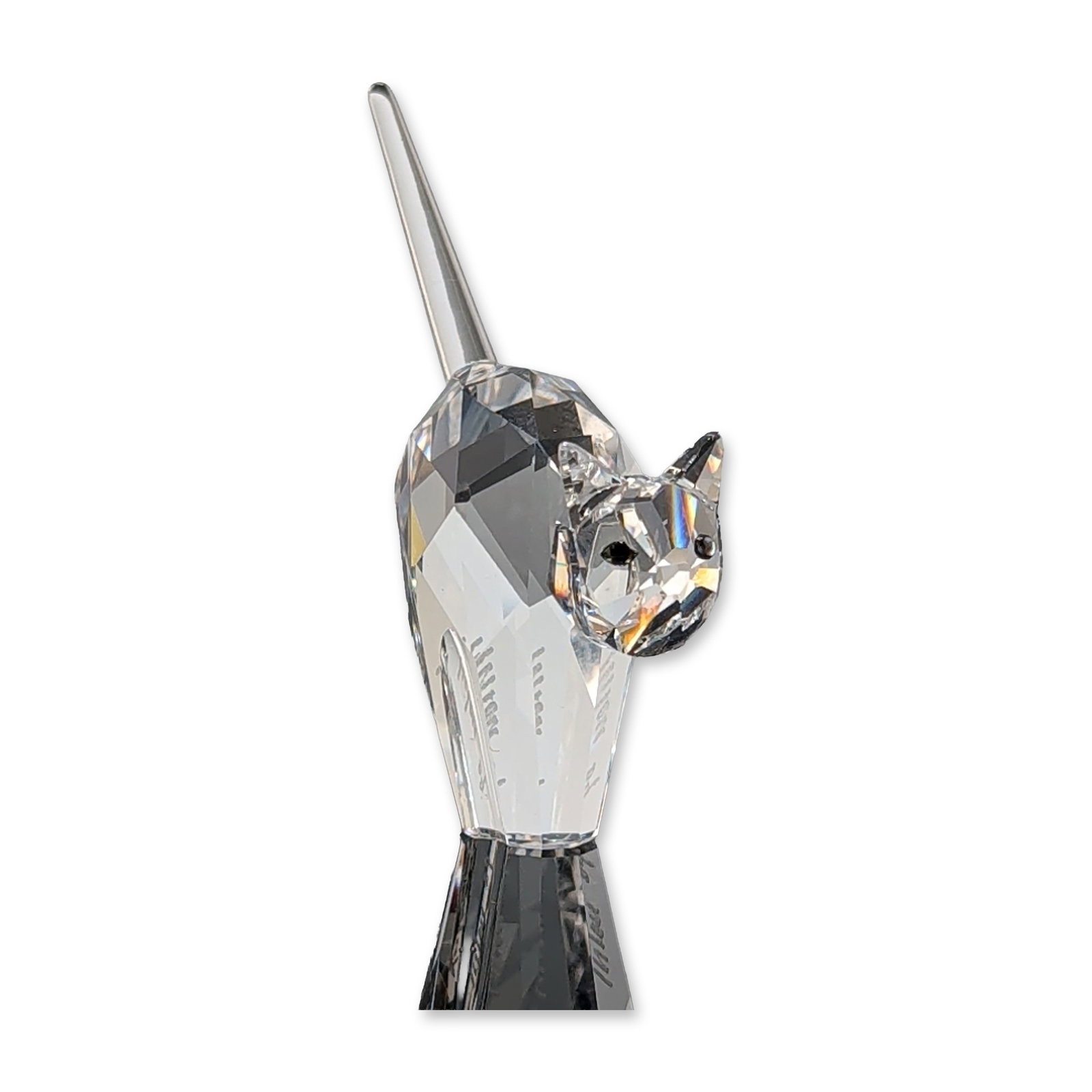 Swarovski Crystal Tomcat Figurine: Swarovski Silver Crystal tomcat figurine constructed from clear faceted crystal, featuring an arched back and pointed tail. The underside bears the acid-etched Swarovski swan logo. Includes an engrave