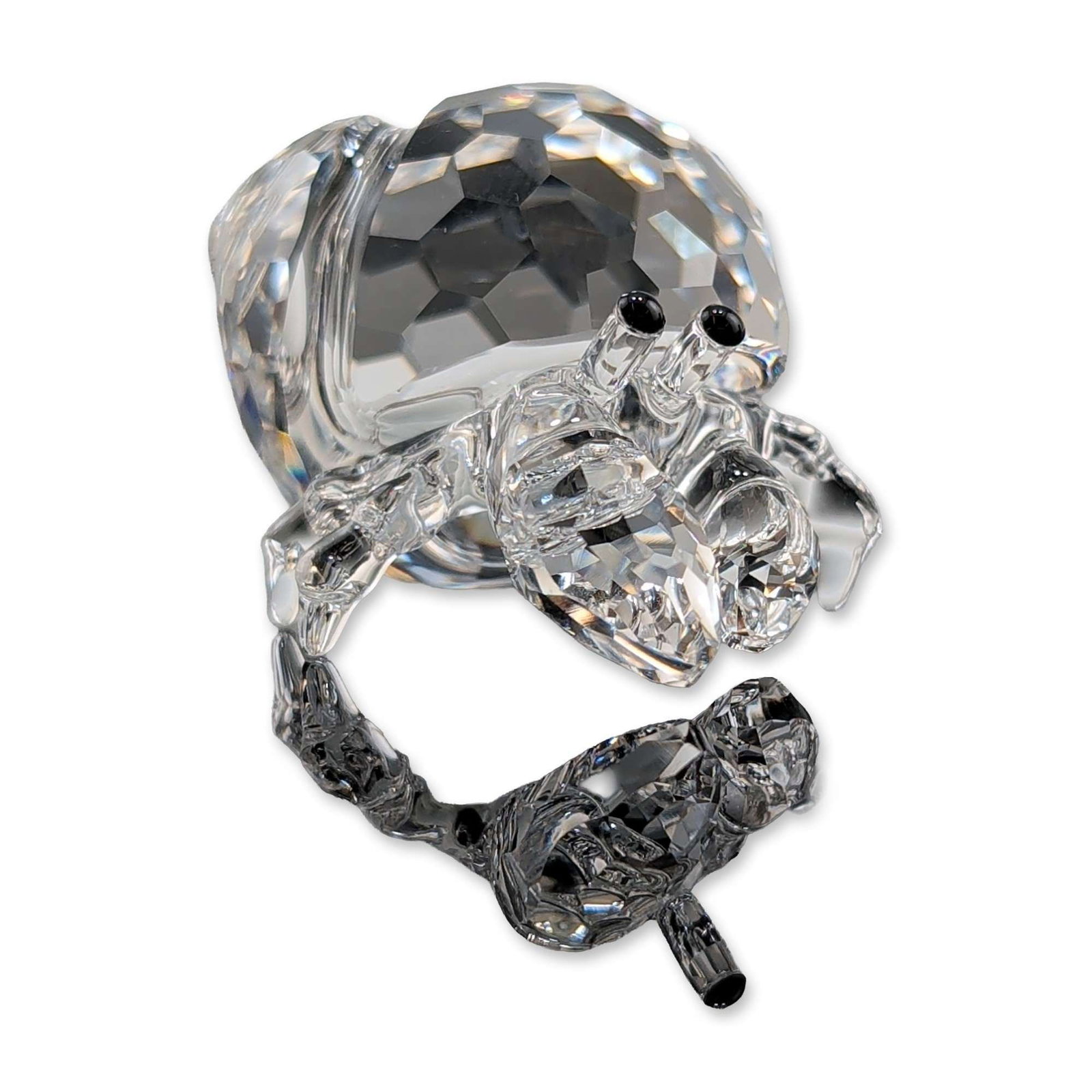 Swarovski Austrian Faceted Crystal Hermit Crab Figurine: Swarovski crystal figurine depicting a hermit crab crafted from faceted clear lead crystal with two small black crystal eyes. The design features a multi-faceted spherical shell with a smooth-bodied c