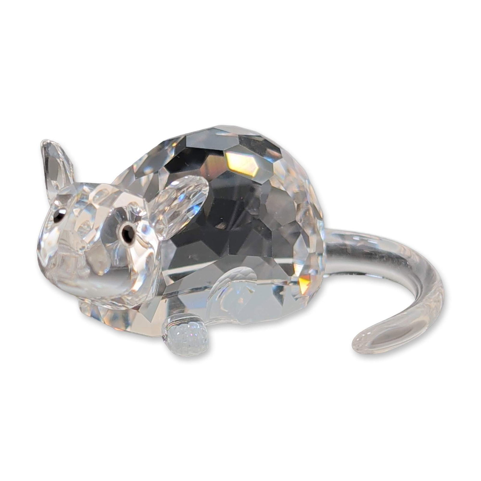 Swarovski Crystal Zodiac Rat Figurine: Rat figurine from the Chinese Zodiac collection, crafted from faceted and smooth clear lead crystal. Features a multifaceted body, head, and ears with smooth paws and a long, curved tail. Set with two