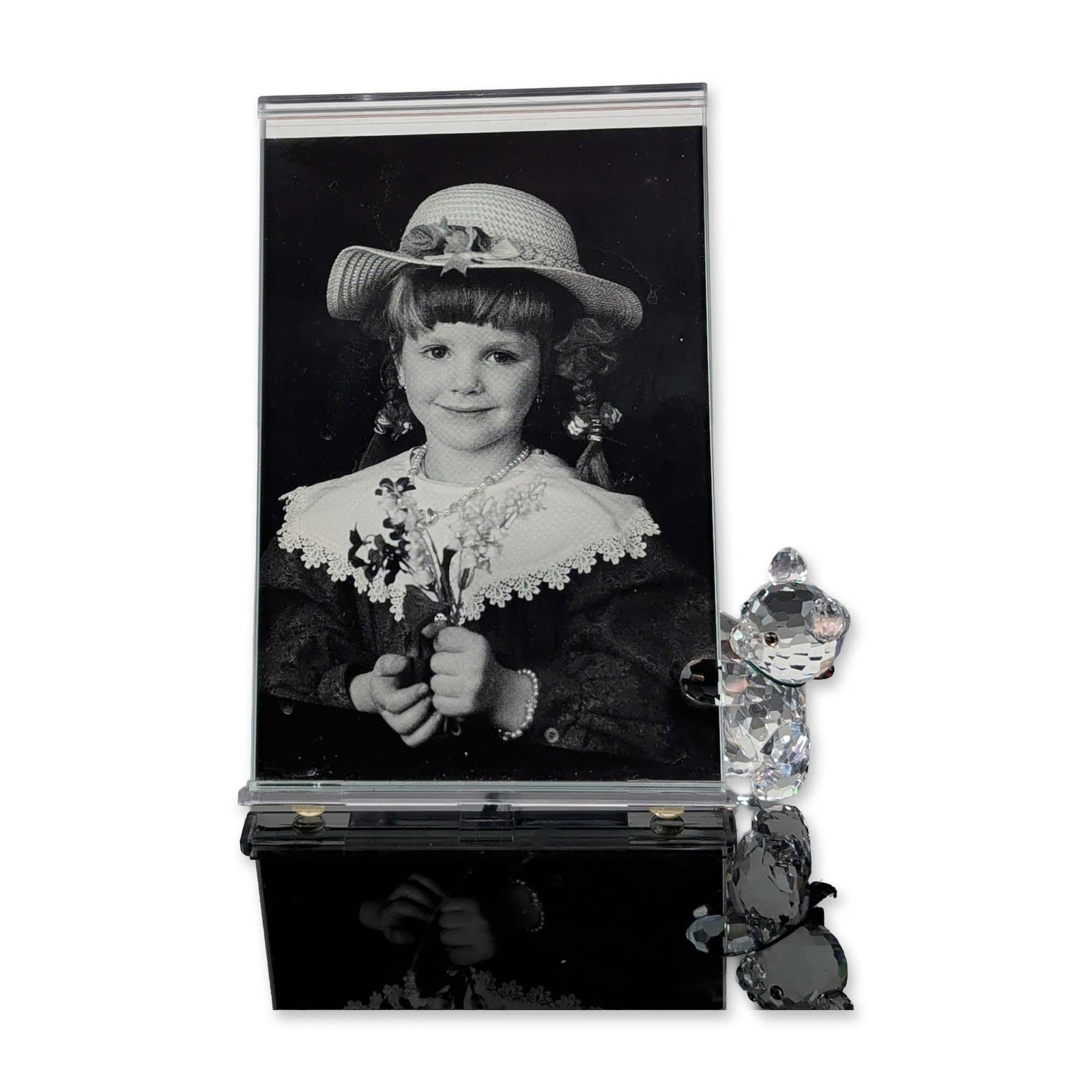 Swarovski Kris Bear Crystal Picture Frame: Vertical picture frame from the Kris Bear series, composed of faceted lead crystal and acrylic. The design features a faceted crystal teddy bear figurine at the lower-right corner with dark eyes, a da