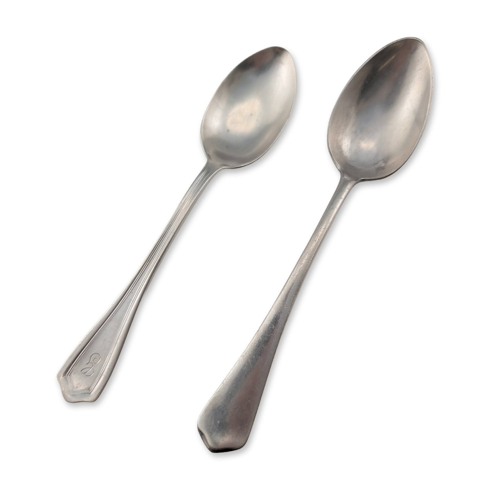2pc Watrous Sterling and German Silver Plate Spoons: Two silver spoons of varying manufacture. One sterling silver spoon by Watrous Manufacturing Company, featuring a script monogram on the handle and a decorative double-ridged border. The reverse is