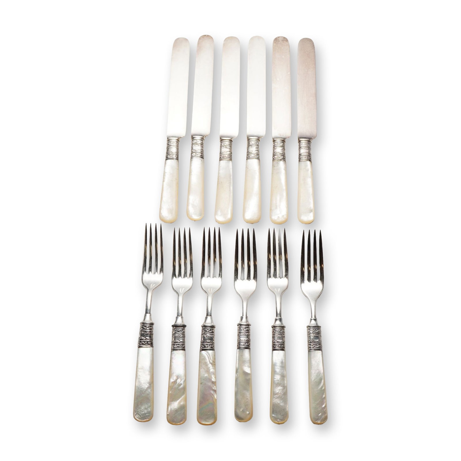 12pc Meriden Cutlery Co. Mother-of-Pearl and Sterling Silver Flatware Set: Meriden Cutlery Company (Meriden, Connecticut). Dessert flatware service for six featuring carved mother-of-pearl handles and ornate sterling silver ferrules. The service consists of six knives and
