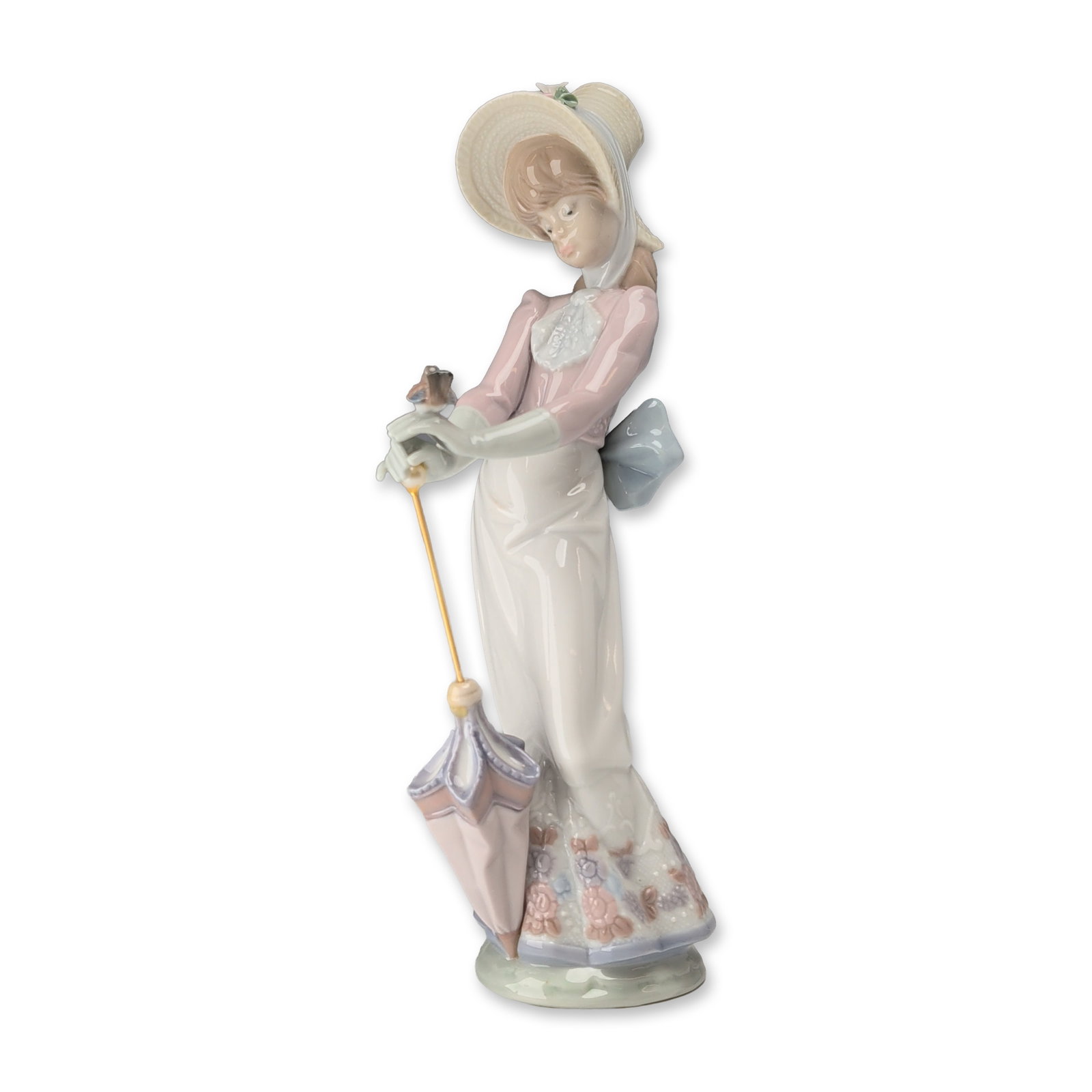 Lladro Garden Song Porcelain Figurine 7618: Lladro (Spain). Garden Song glazed porcelain figurine, model number 7618, sculpted by Juan Huerta. The figure depicts a young woman in late 19th-century attire, featuring a pale pink bodice with a whi