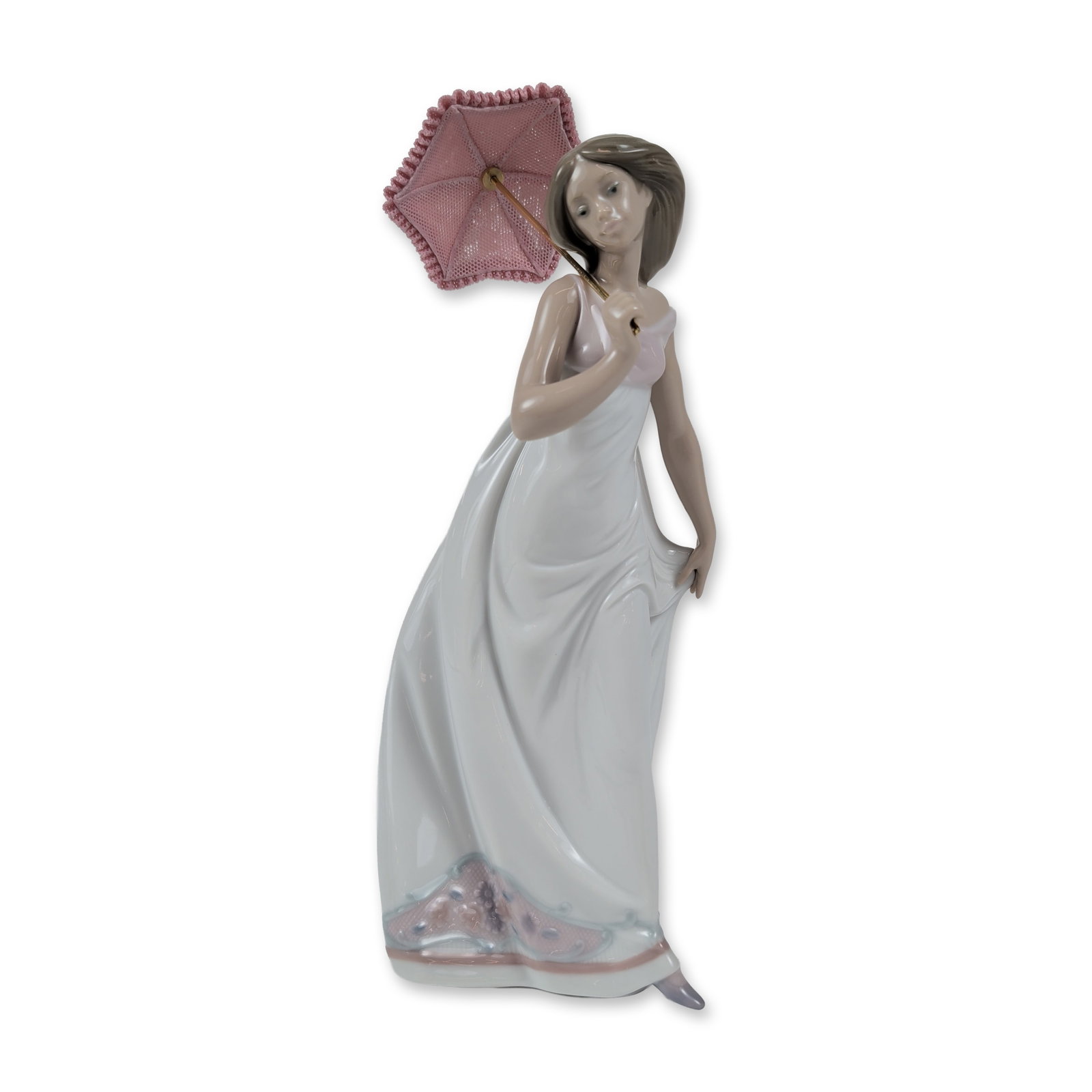 Lladro Porcelain Figurine, Afternoon Promenade 01007636: Lladro (Spain), 1995. Afternoon Promenade (Paseo de Tarde) glazed porcelain figurine, model number 7636. The piece depicts a young woman in a flowing white gown accented with a lavender and floral mot
