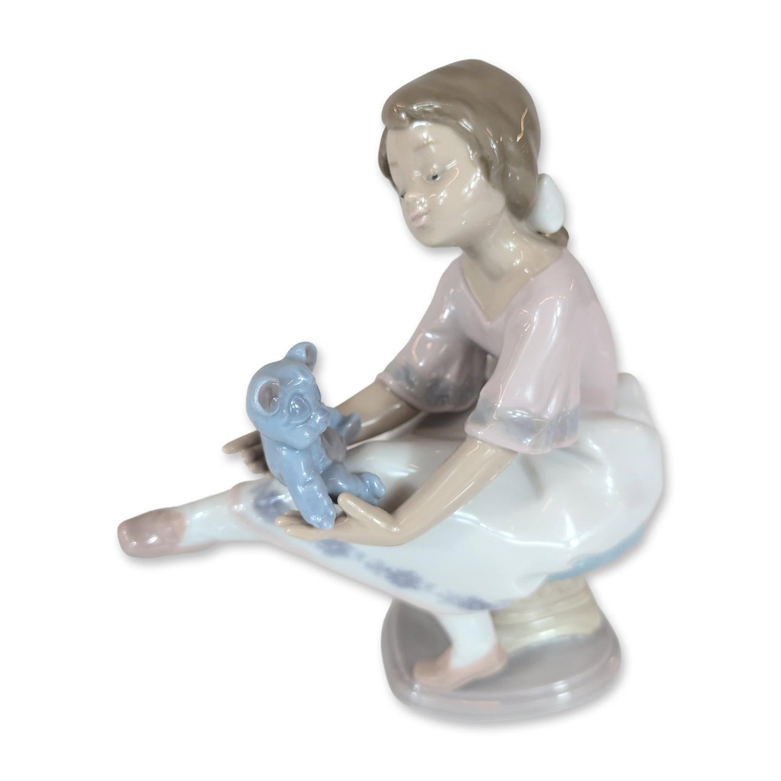 Lladro Spanish Porcelain Best Friend Figurine 01007620: Glazed porcelain figurine titled Best Friend (Spanish title: Columpiando al Osito), model number 7620. The piece depicts a seated young girl wearing a pink short-sleeved blouse and a white skirt decor