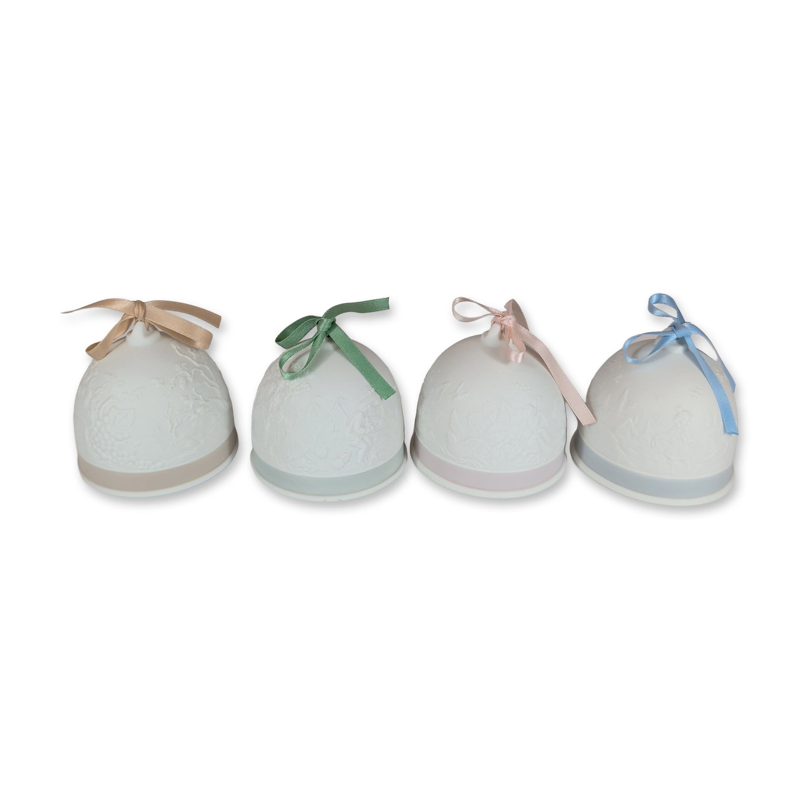 4pc Lladro Porcelain Seasonal Bells: Lladro Collectors Society. Set of four seasonal commemorative bells in white matte bisque porcelain. Each bell is decorated with bas-relief motifs of flowers and angels and features a distinct colored