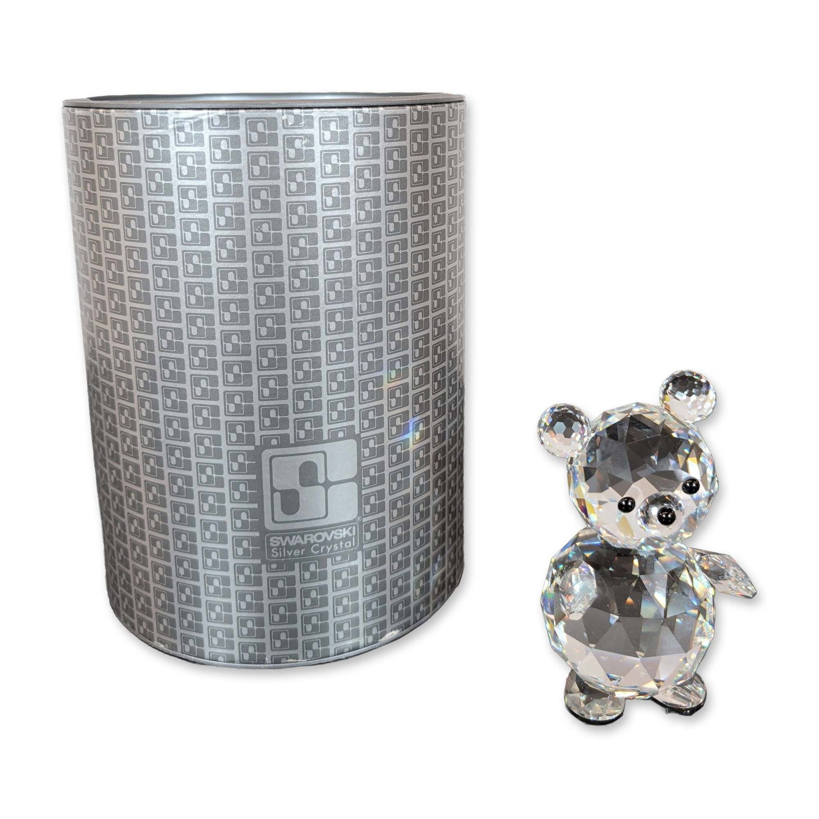 Swarovski Silver Crystal Teddy Bear Figurine: Swarovski, Austria, faceted lead crystal bear figurine with black crystal accents representing the eyes and nose. The piece depicts a seated bear with a rounded head and circular ears. Etched block lo